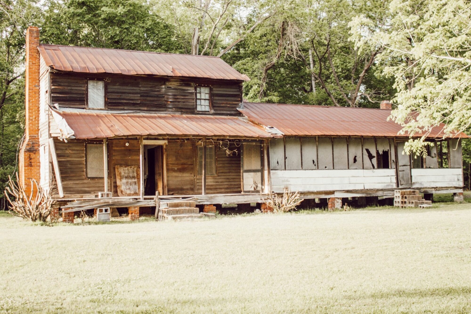 1800's NC farmhouse with weathered wood siding and large front porch