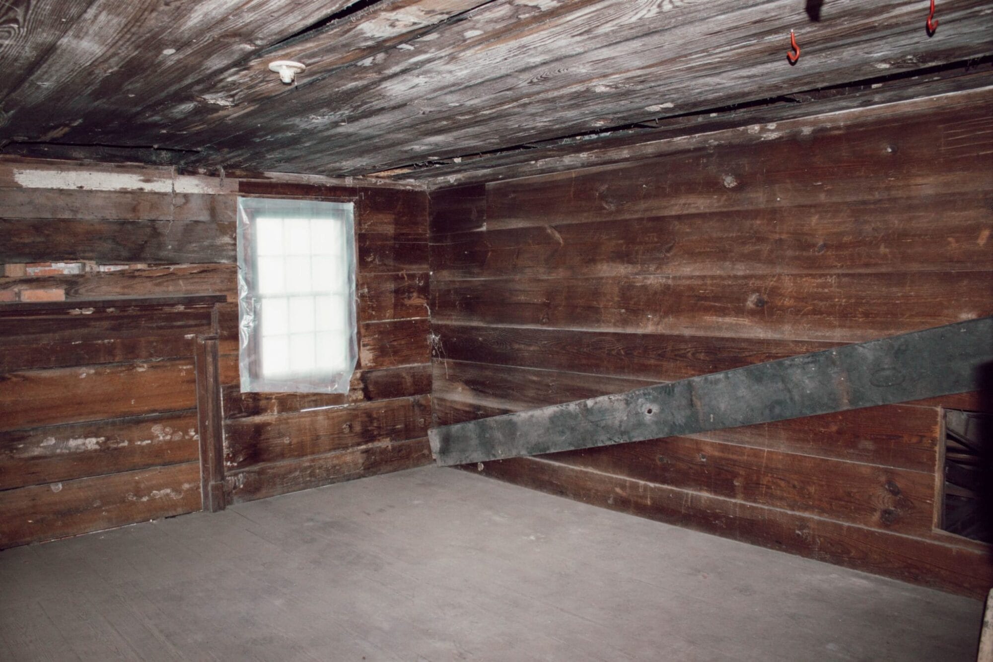 1800's NC farmhouse upstairs bedroom with original shiplap on walls and wood floors