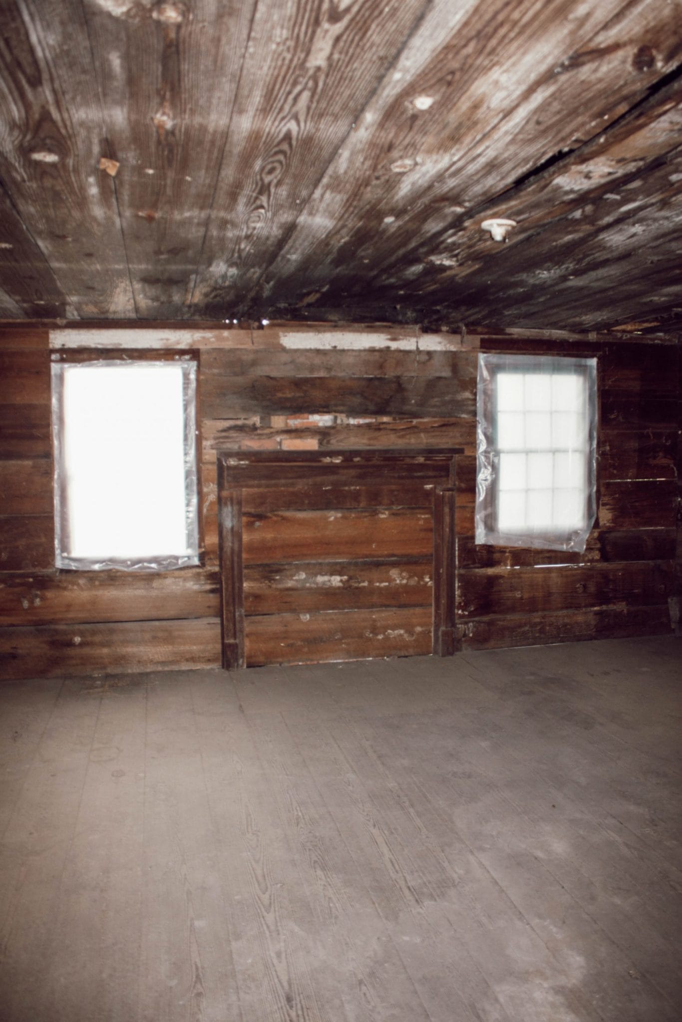 1800's NC farmhouse upstairs bedroom with original shiplap on walls and wood floors