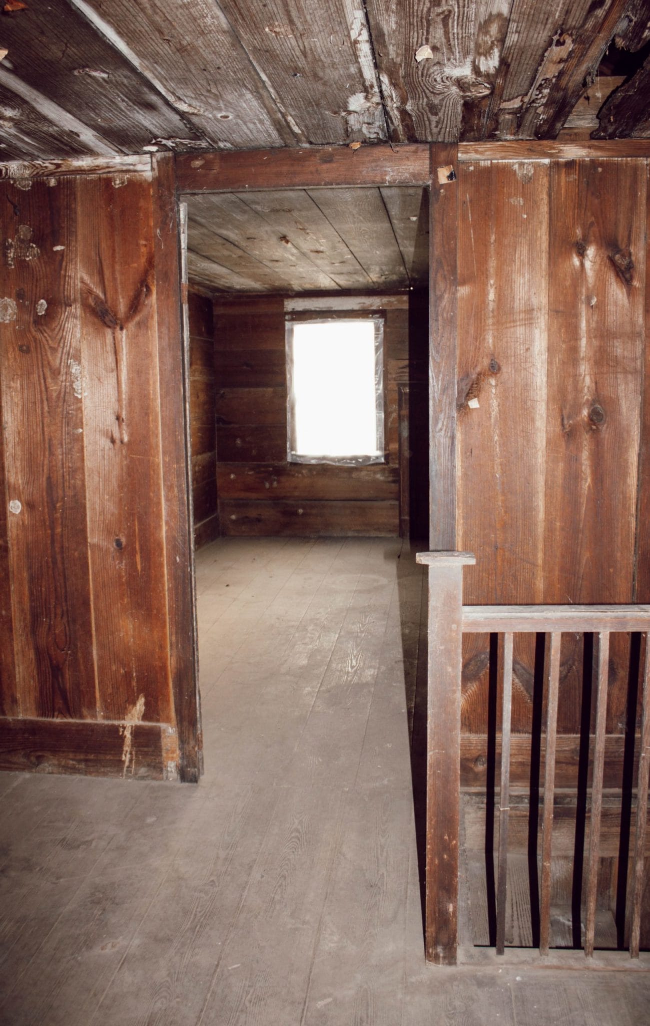 1800's NC farmhouse upstairs bedroom with original shiplap on walls and wood floors