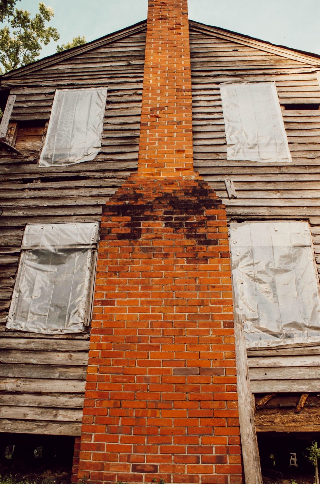 red brick chimney of historic 1800's NC farmhouse before renovation