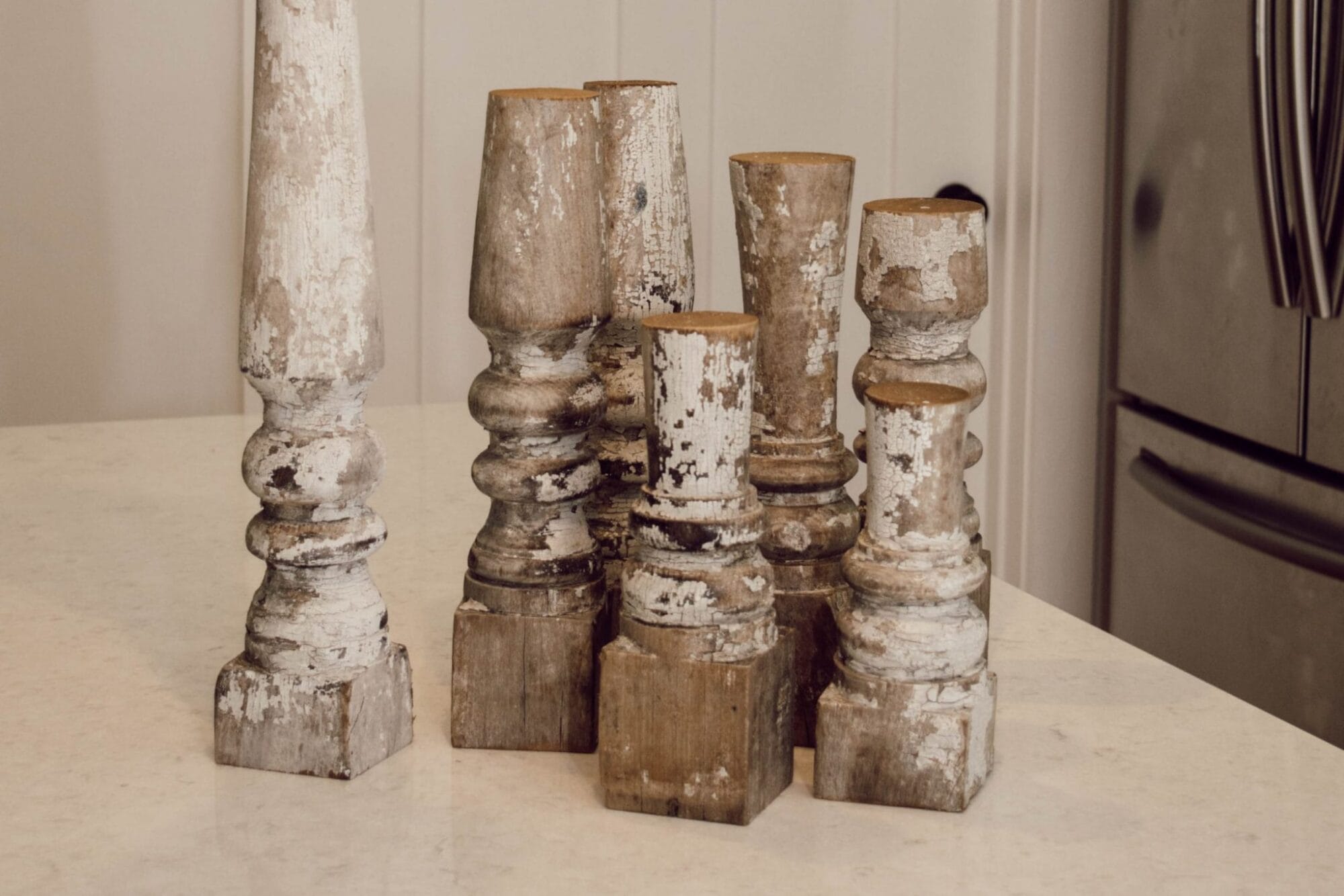 chippy white candle holders combine white and woodgrain farmhouse design elements