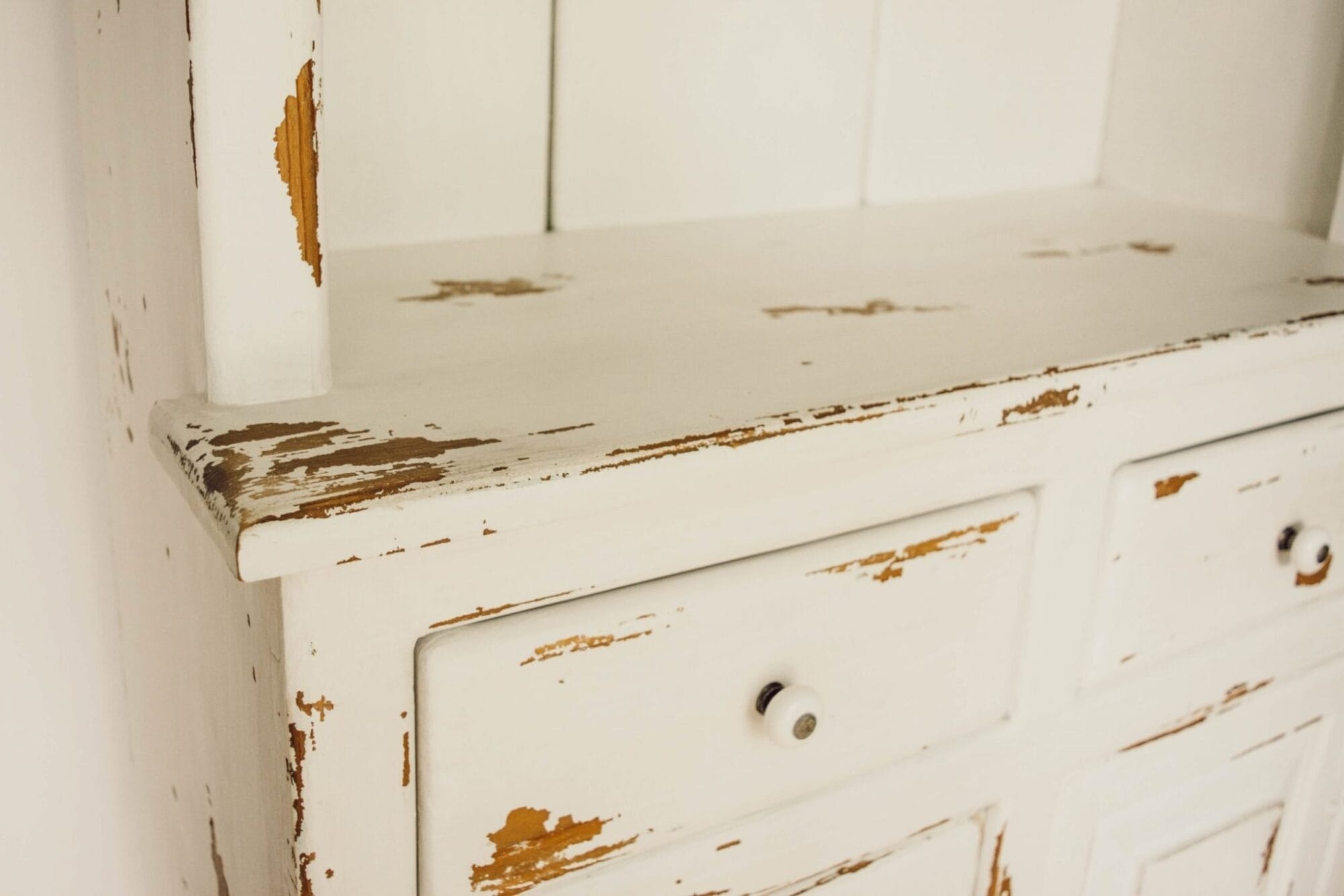 distressed white painted farmhouse style storage cabinet