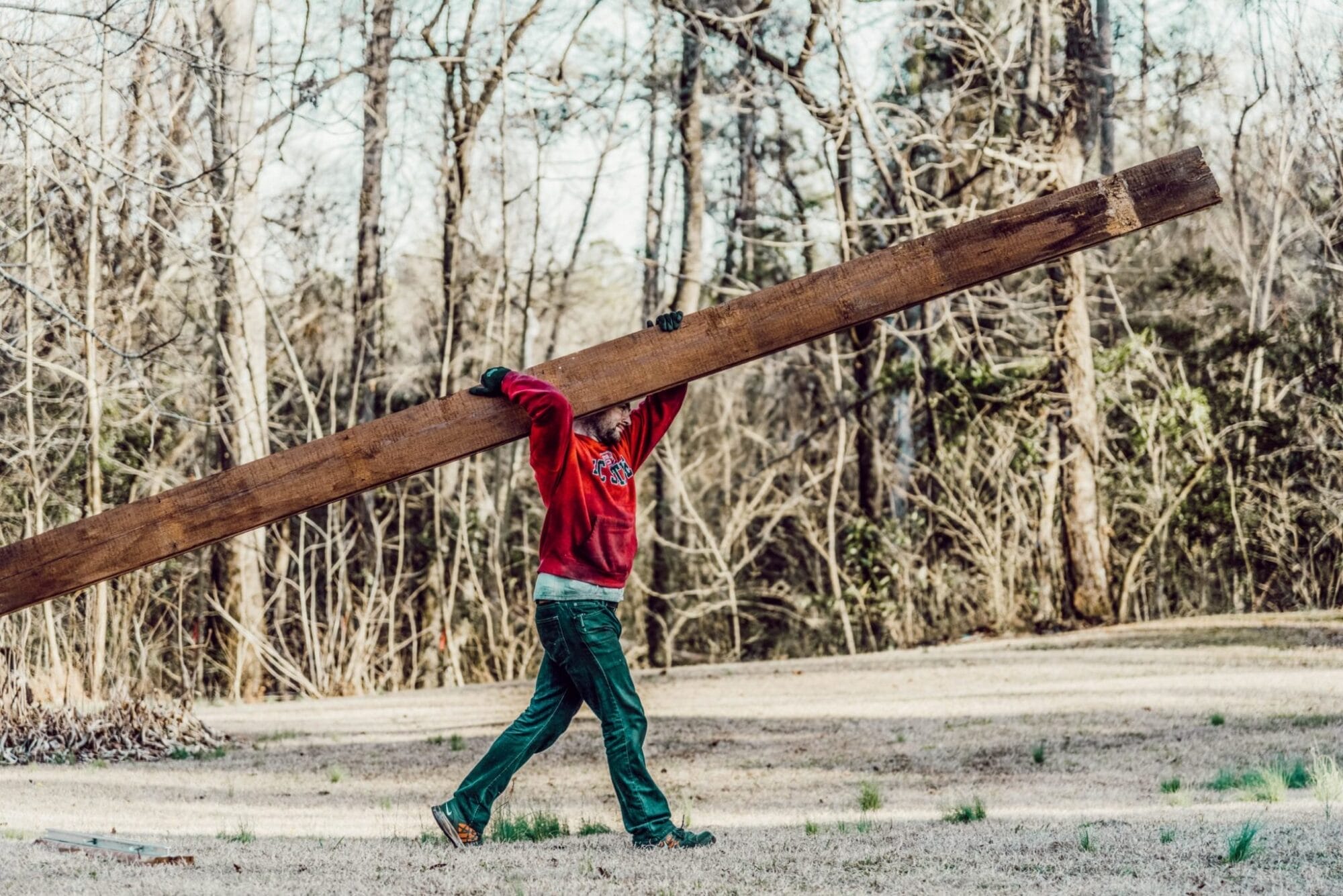 man carrying salvaged shiplap