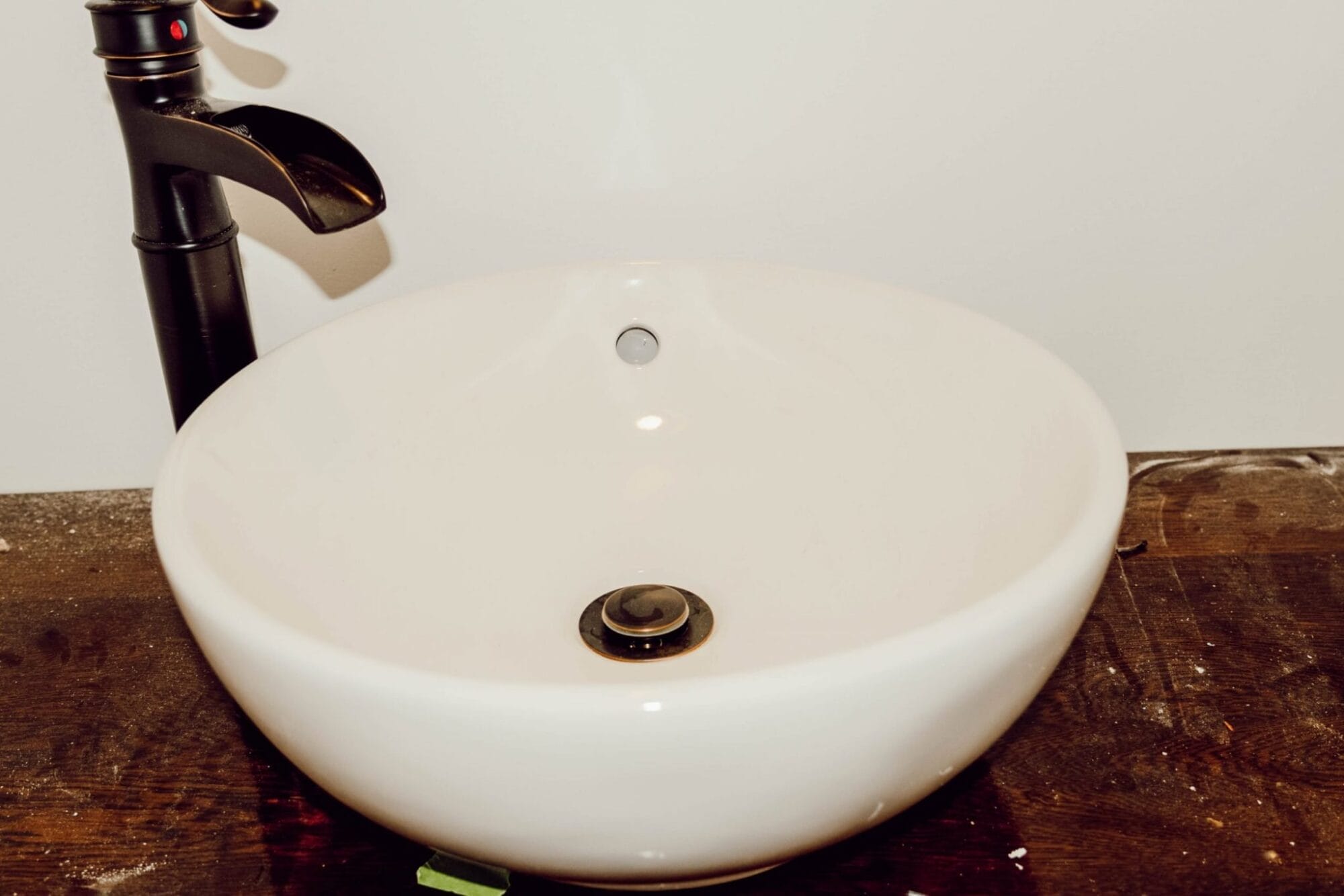 bowl sink on wood vanity with oil rubbed bronze faucet