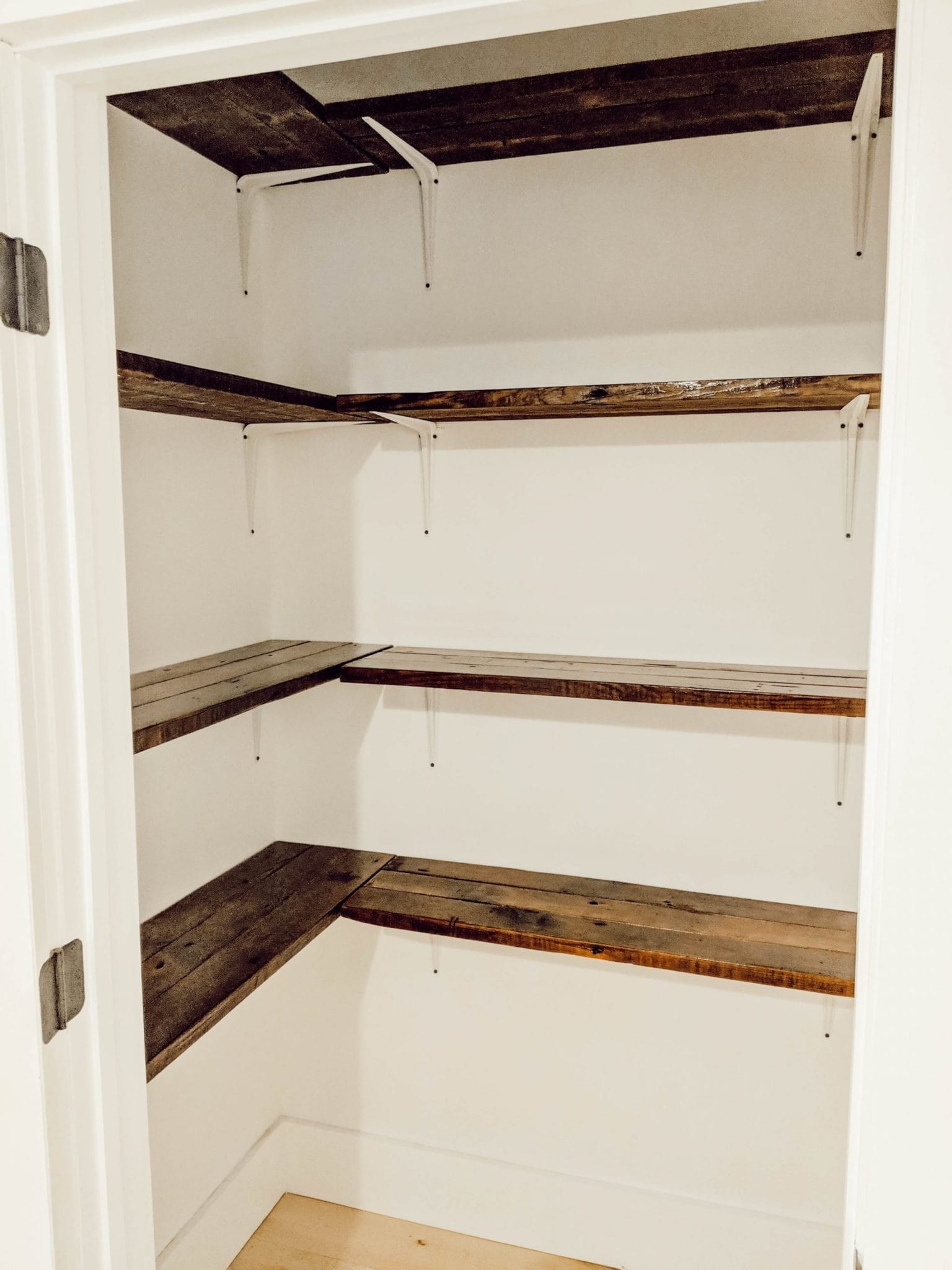 old wood flooring turned into farmhouse style linen closet shelves