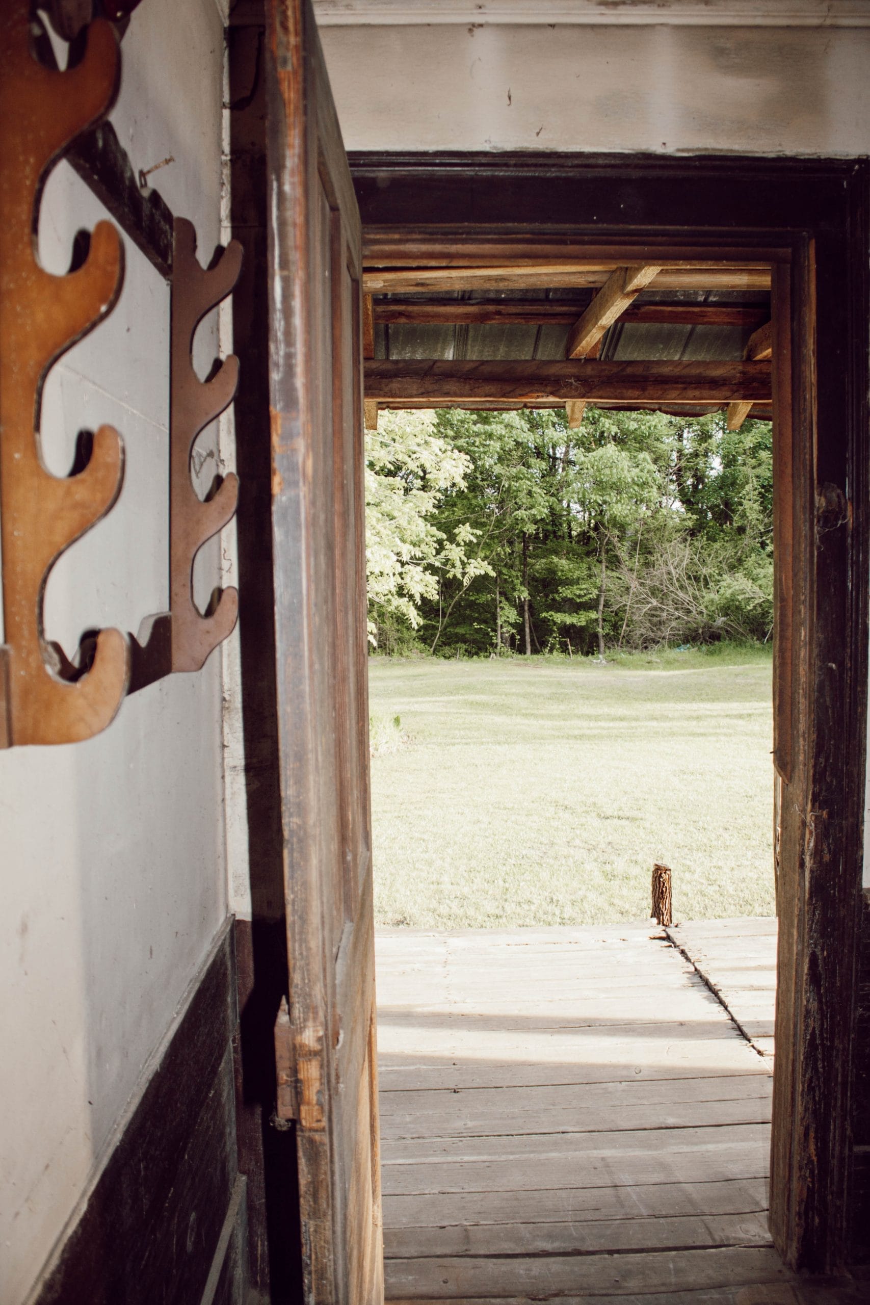 vintage wooden gun rack hanging in old farmhouse