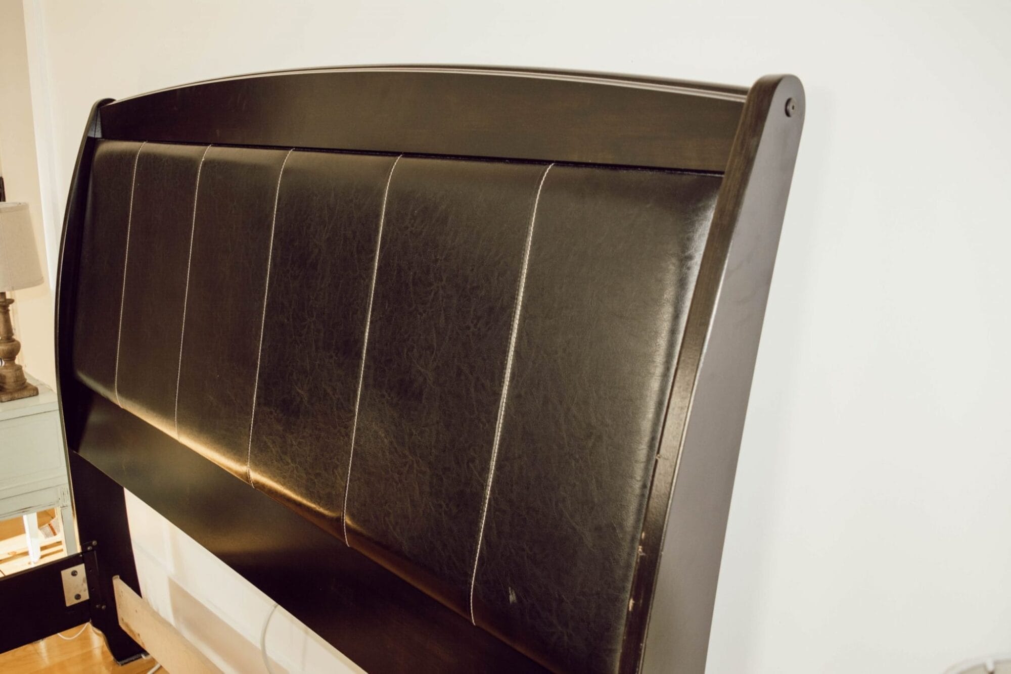 black headboard with faux leather upholstery