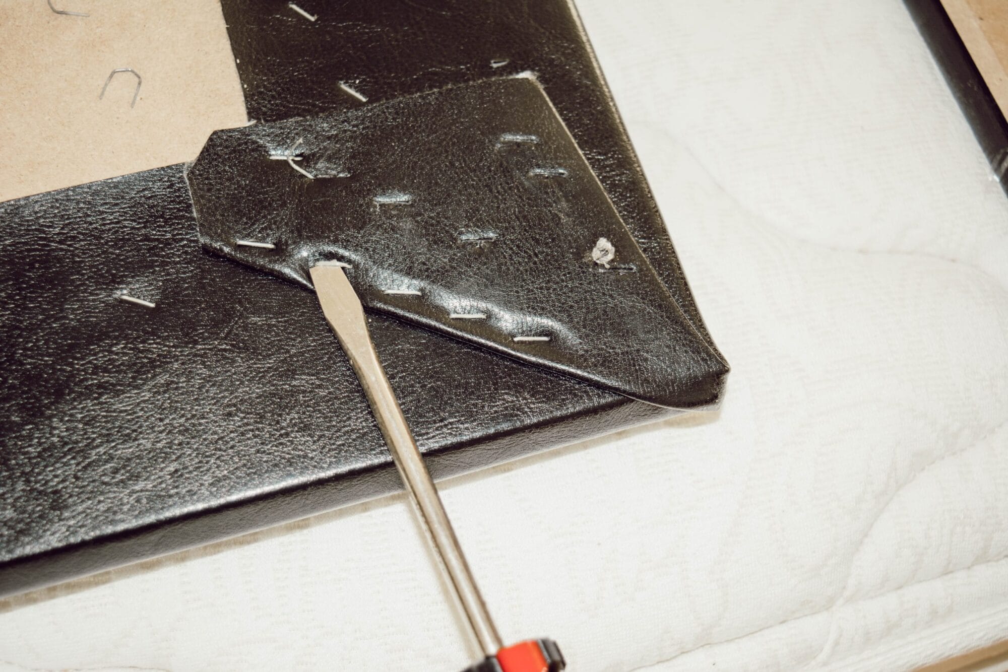 screwdriver removing upholstery staples