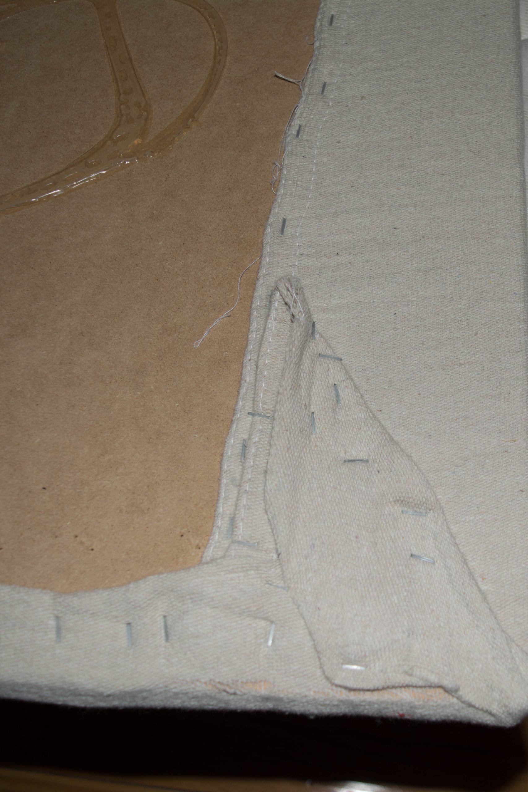 new drop cloth upholstery stapled to back of headboard