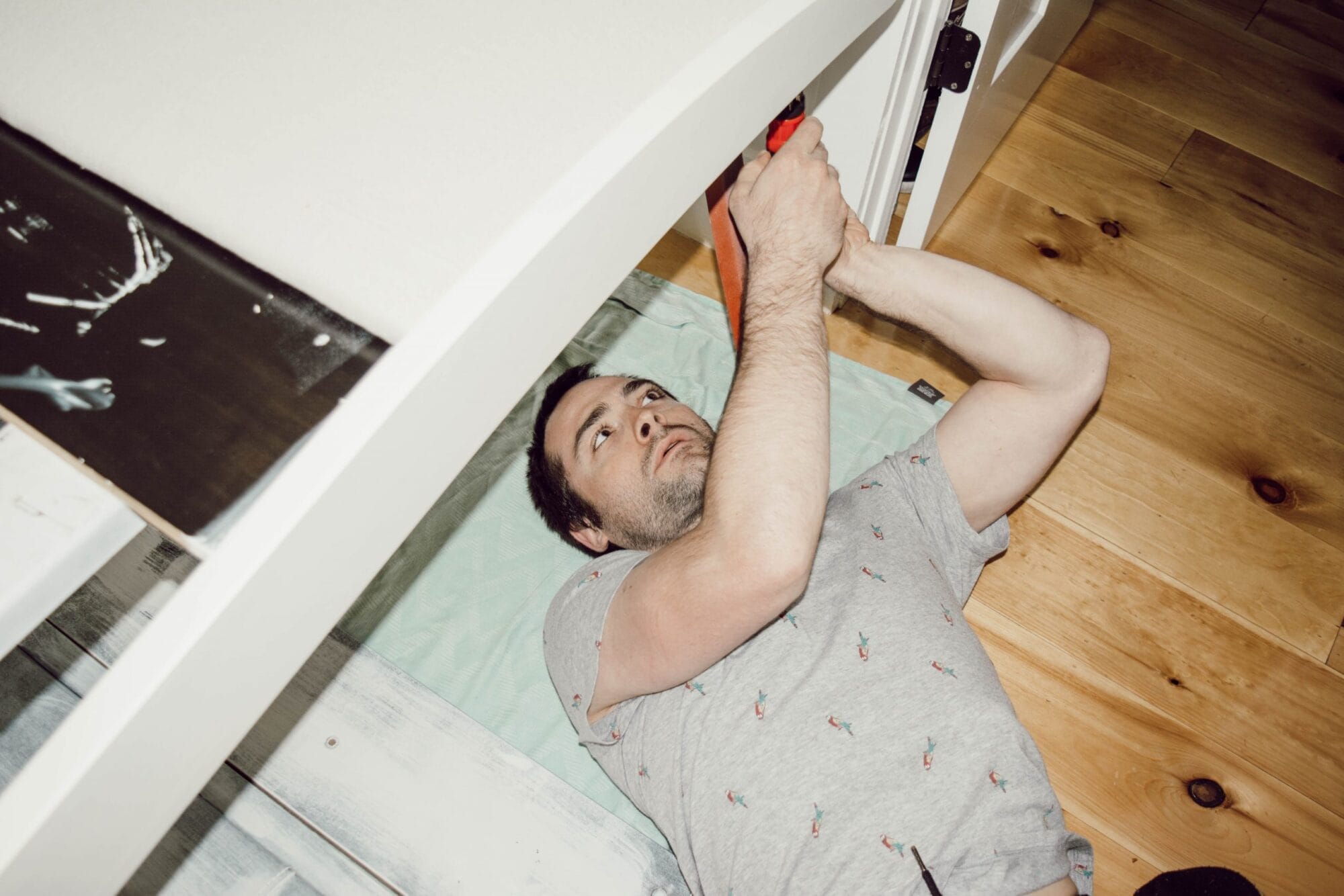man reassembling headboard