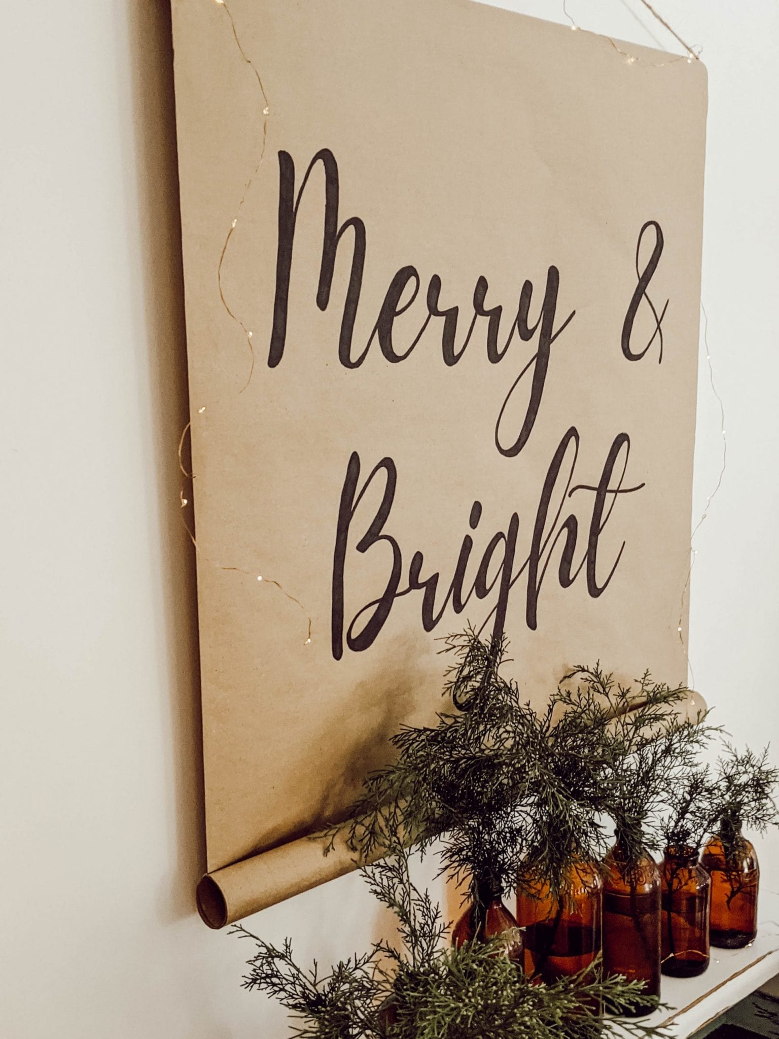 craft paper scroll sign that says Merry and Bright