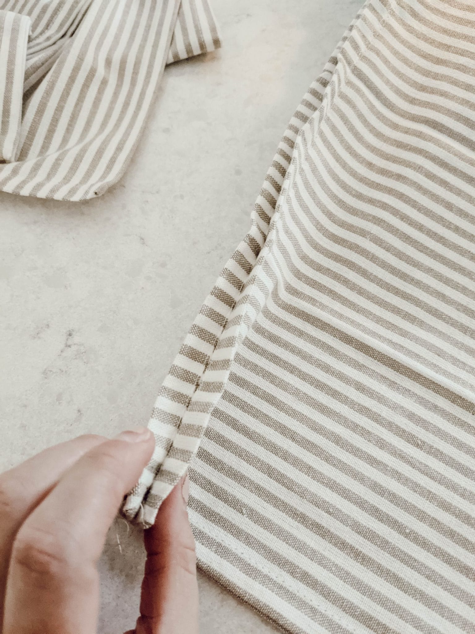 edge details of neutral striped pillow cover