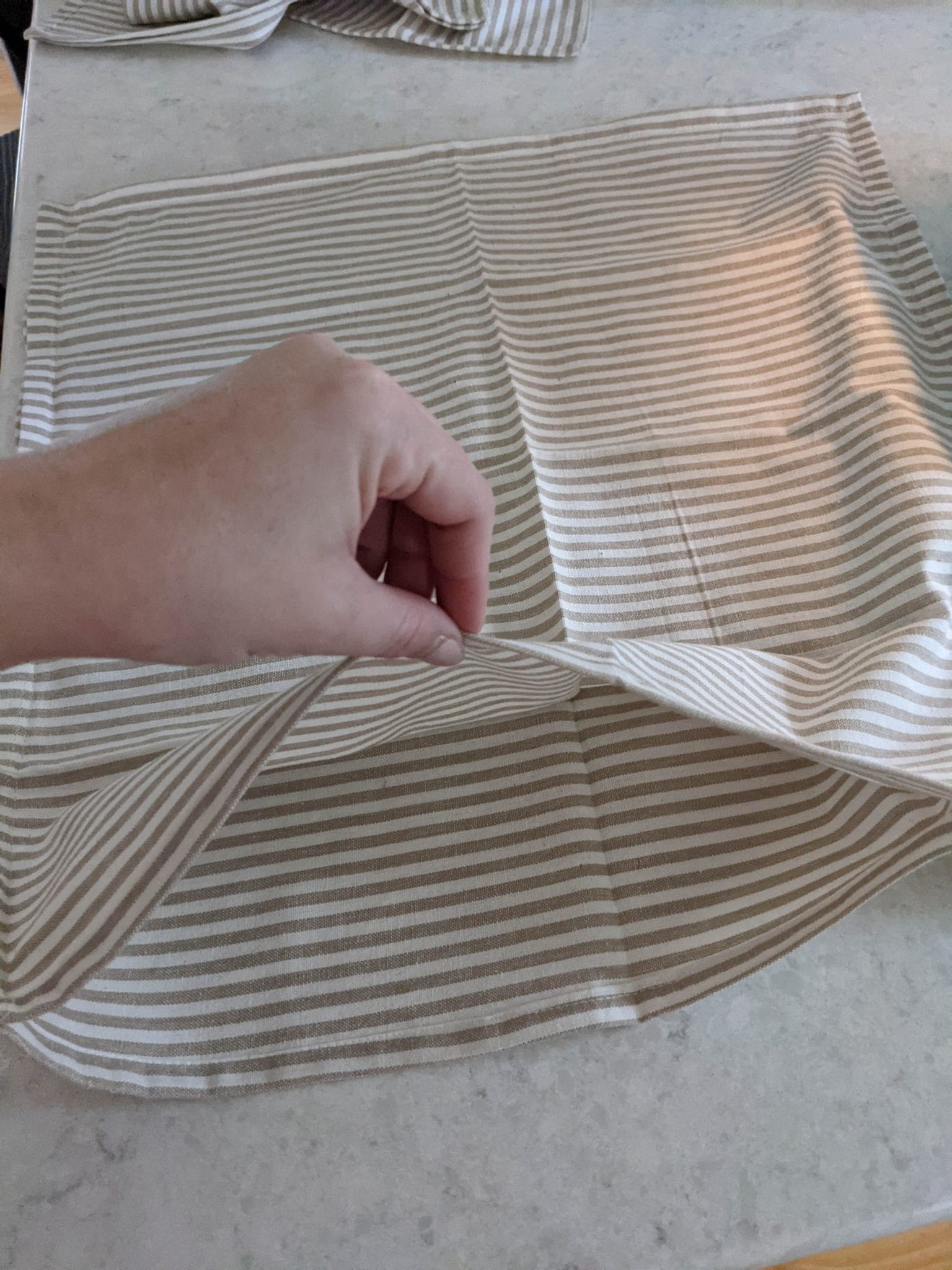 sewing cloth napkins to make a DIY pillow cover