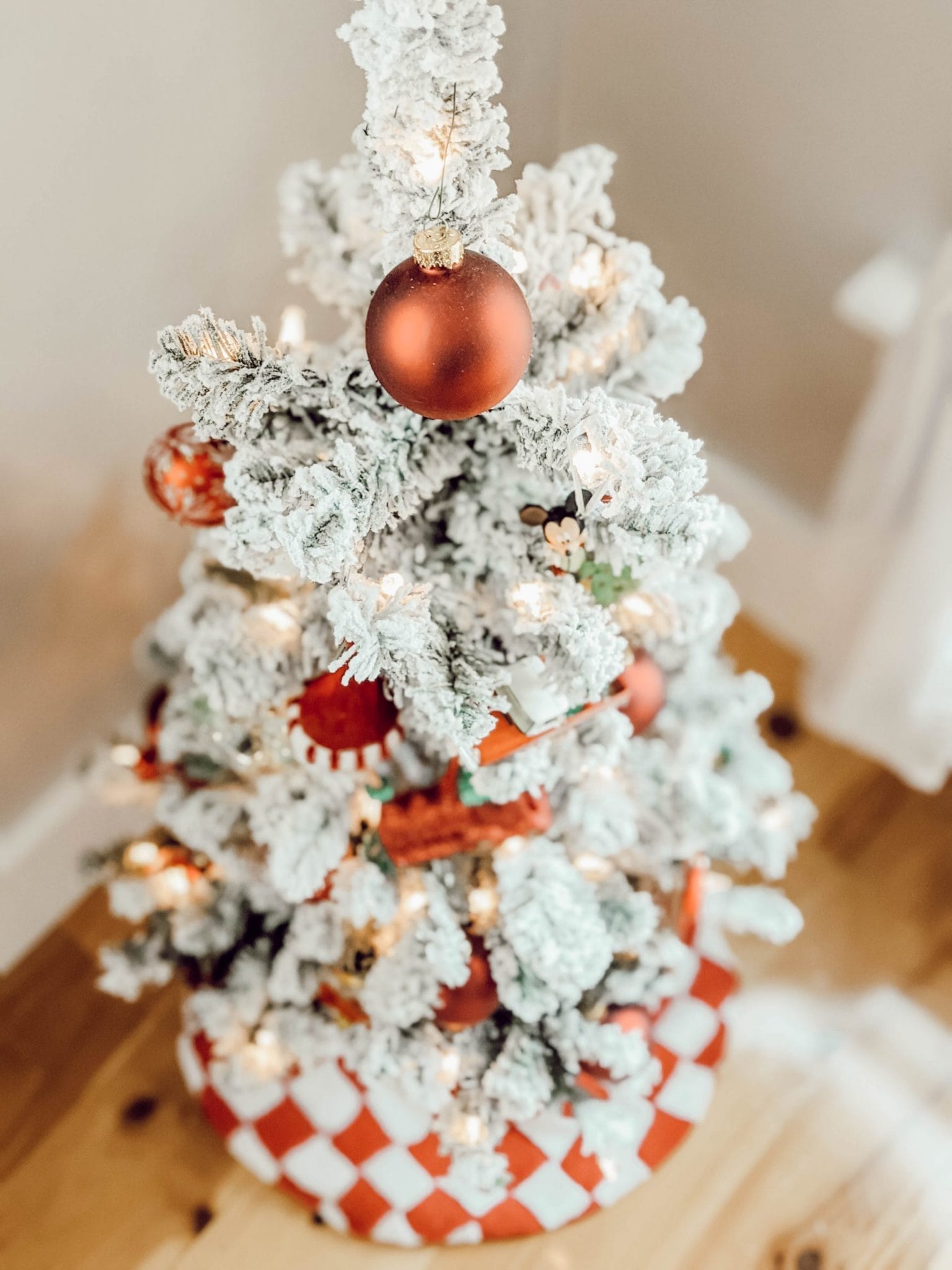 mini flocked Christmas tree with red ornaments