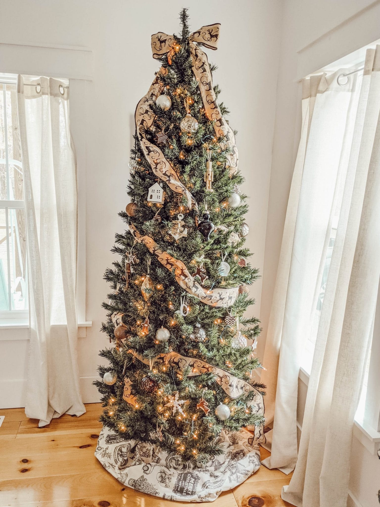 neutral themed Christmas tree with cream colored vintage print tree skirt