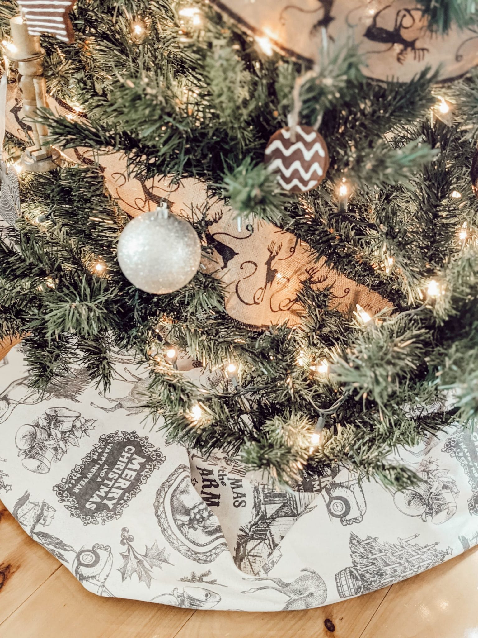 neutral themed tree with cream colored vintage print tree skirt