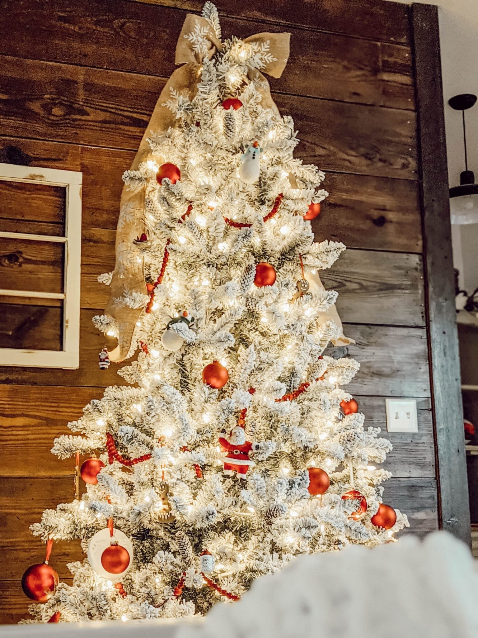 flocked Christmas tree with classic red ornaments