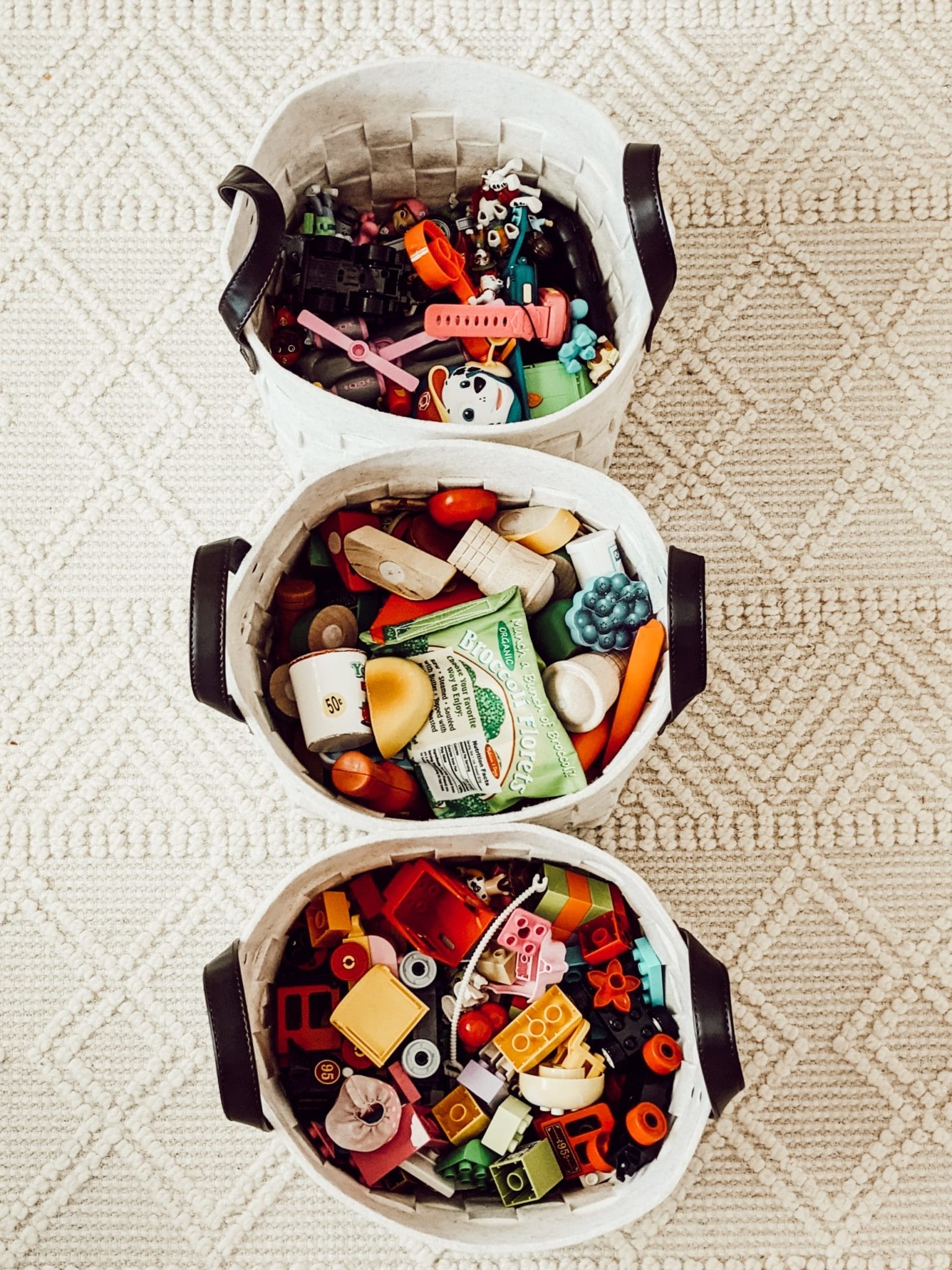 neutral playroom storage baskets filled with toys