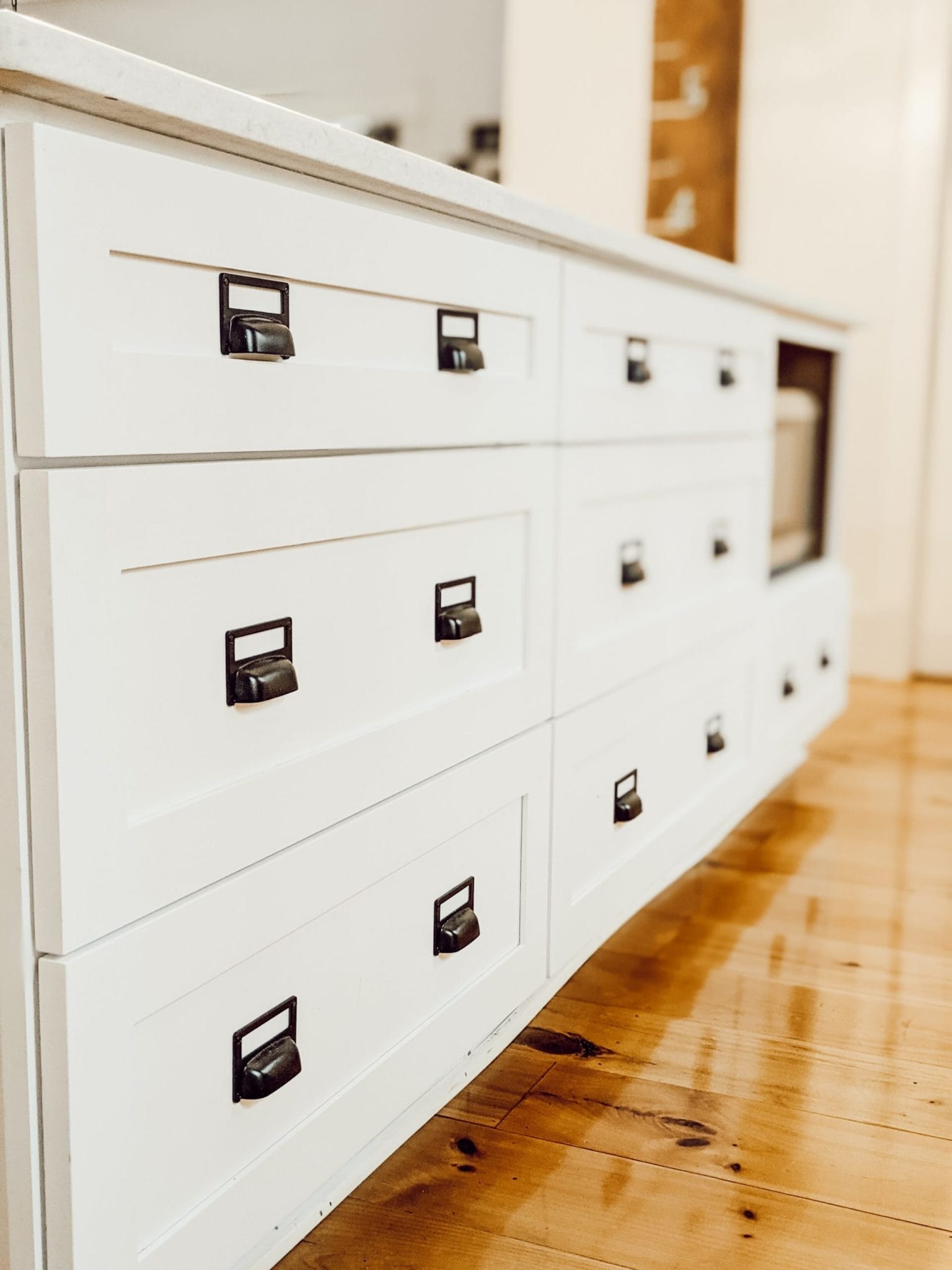 kitchen island full of drawers with black hardware