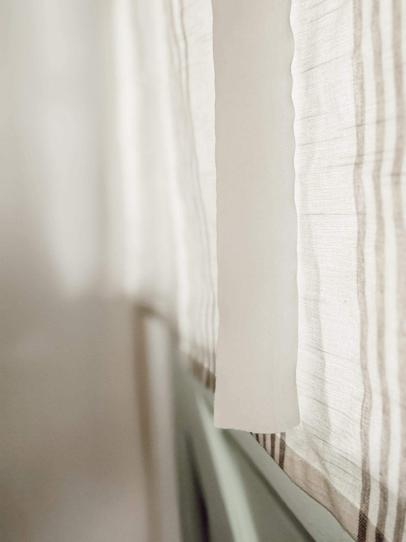 open ties on white and gray tie-up curtains