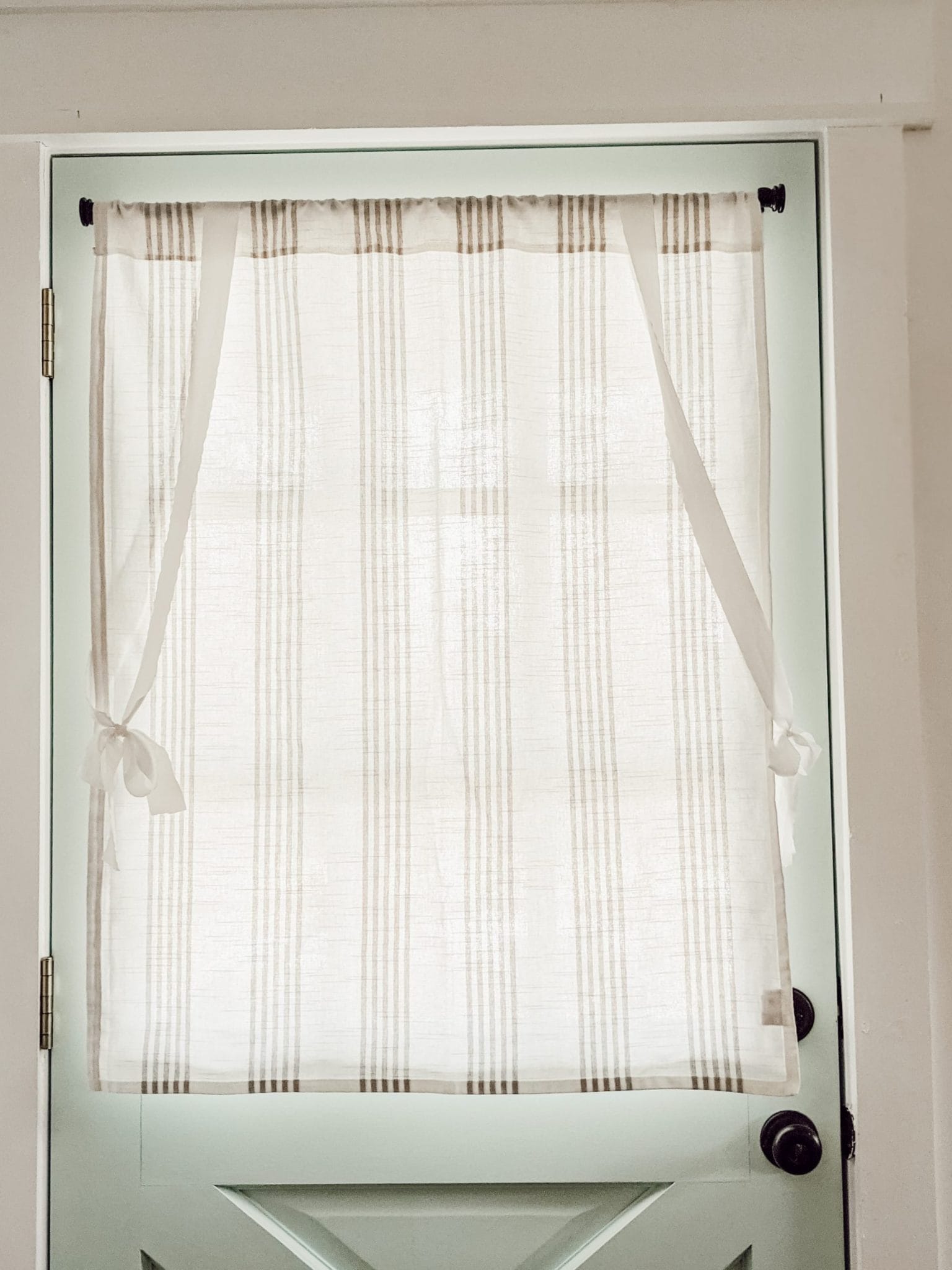 white and gray striped window treatment