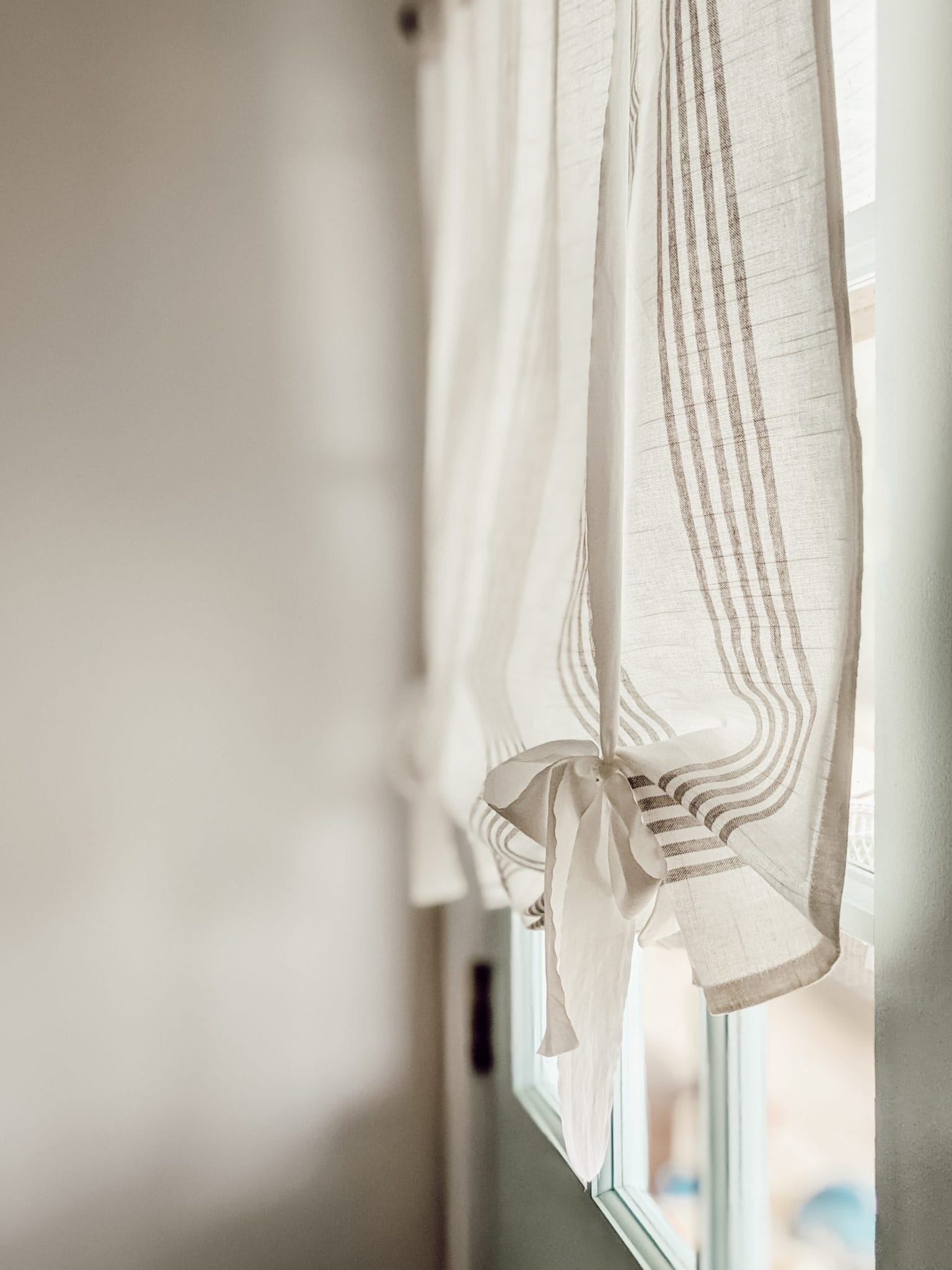 white and gray striped tie-up shades