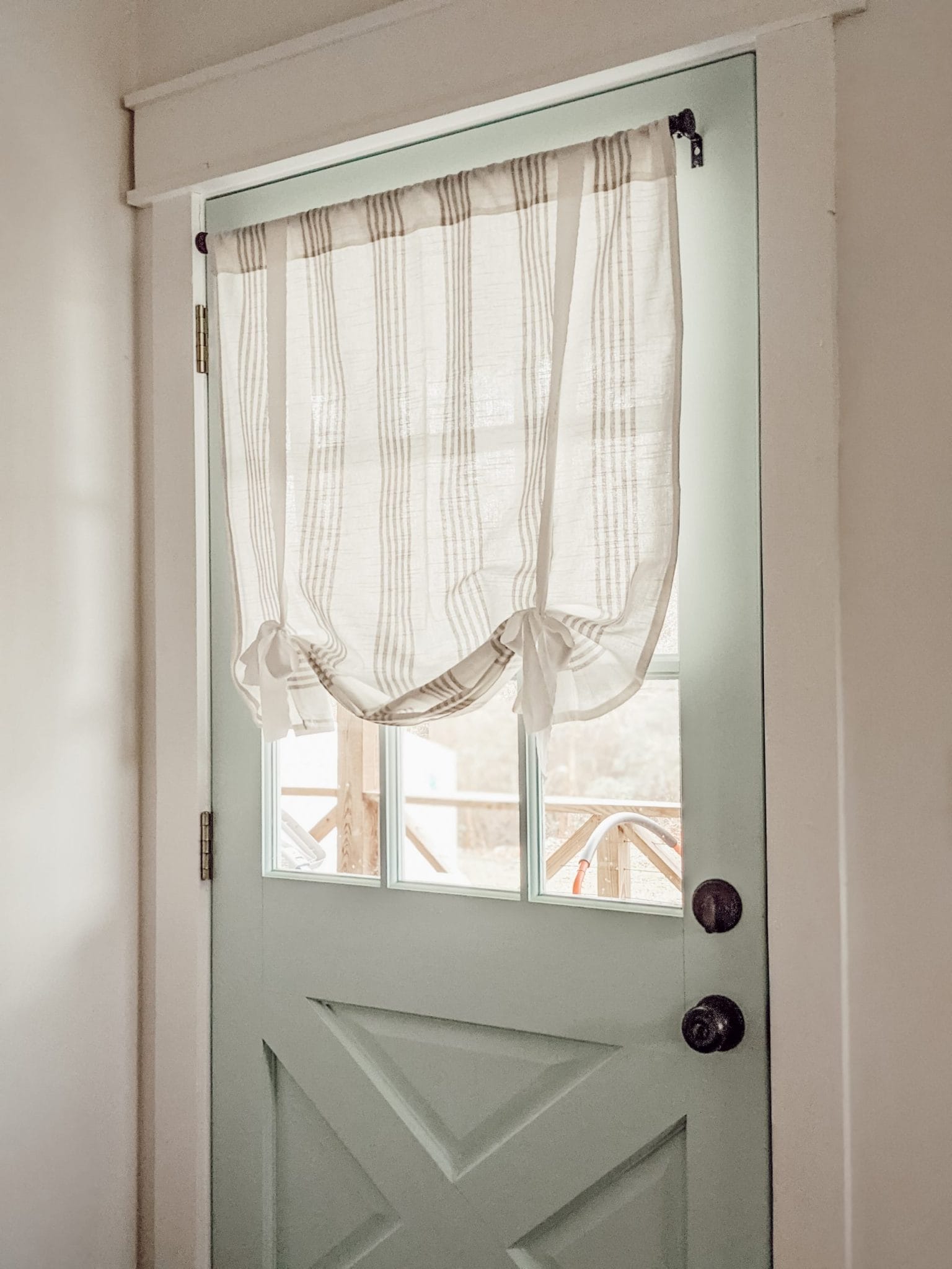 DIY tie-up curtain on blue door