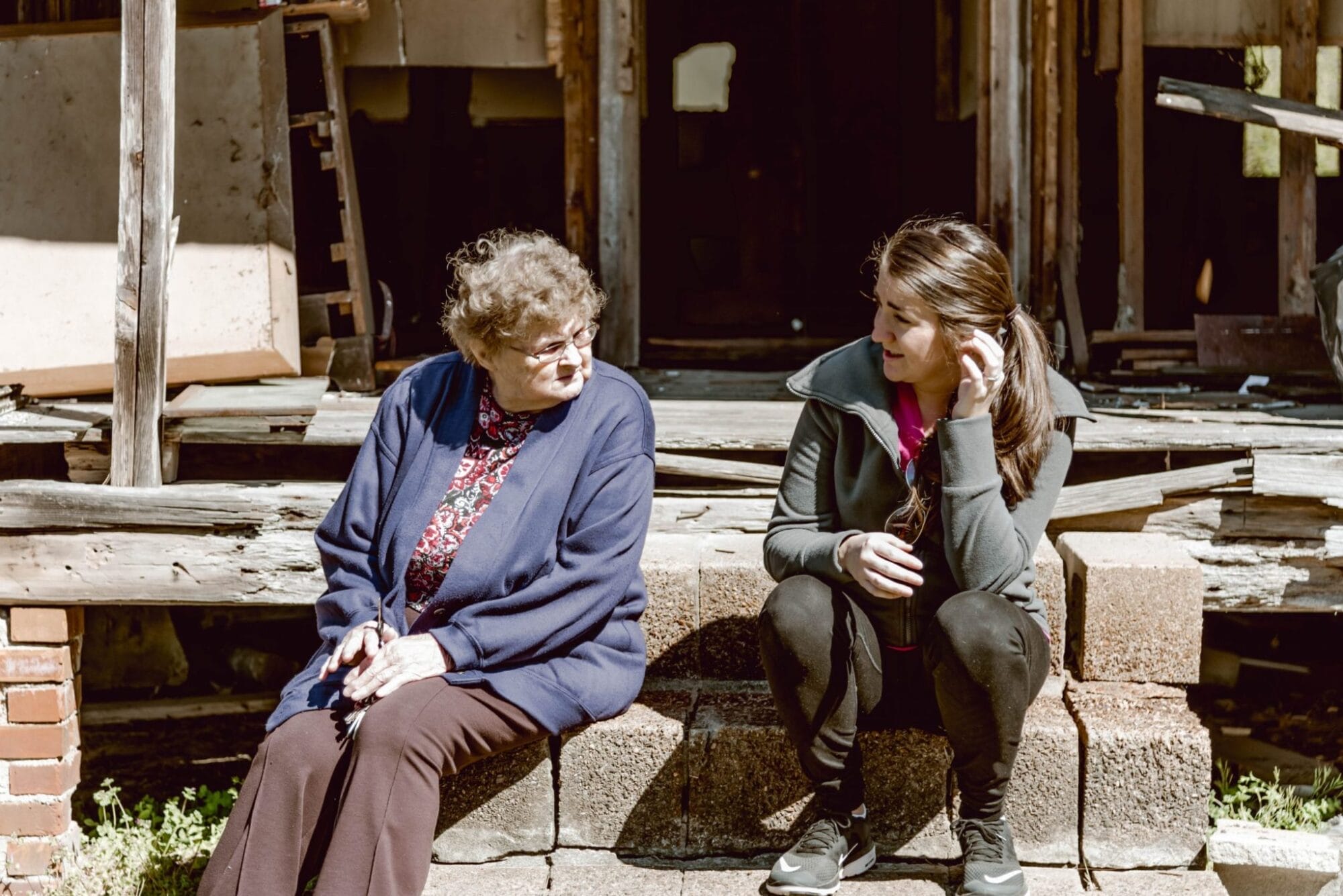 great aunt and great niece on the old farmhouse porch steps