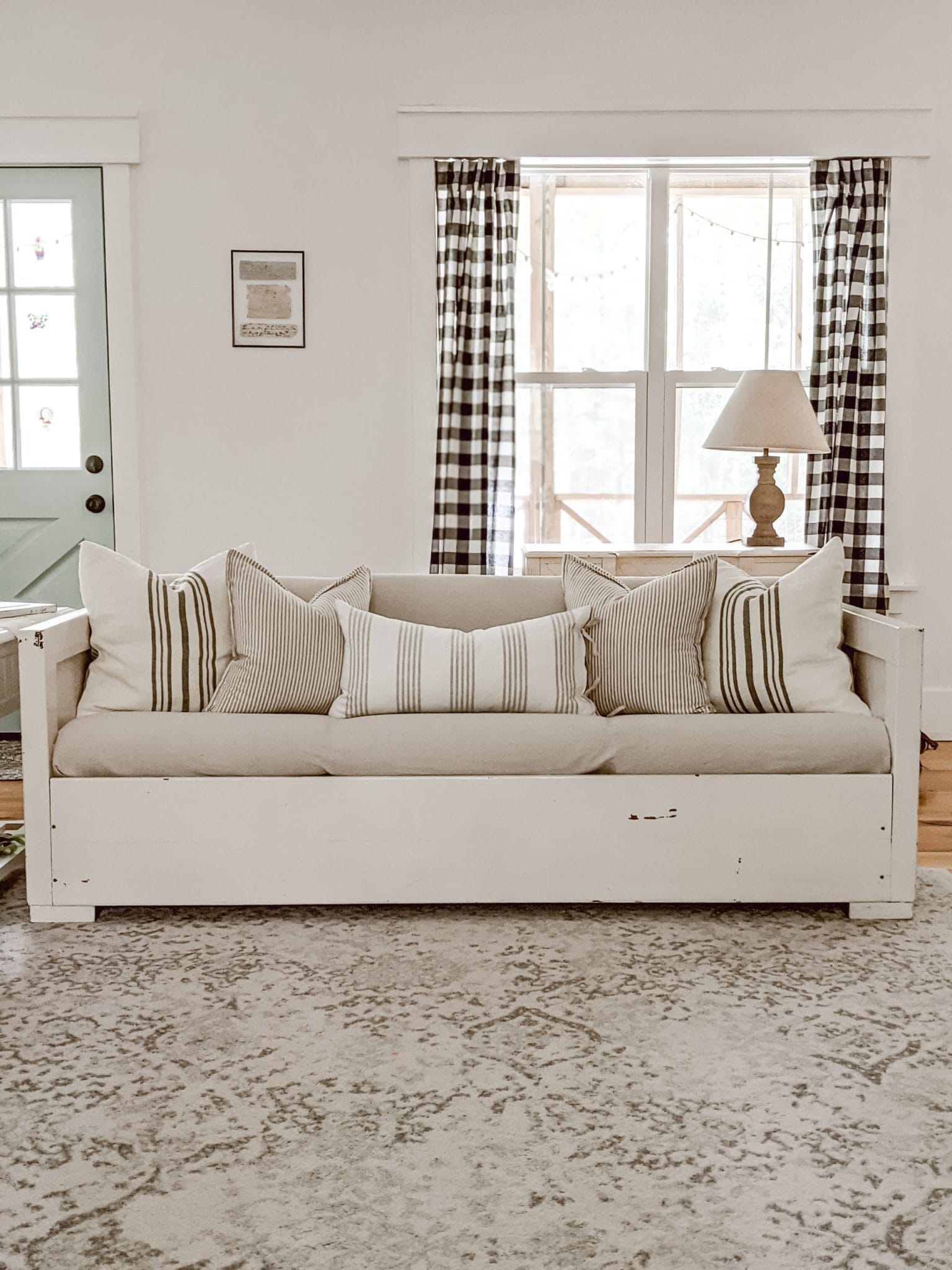 farmhouse living room couch with lots of striped throw pillows