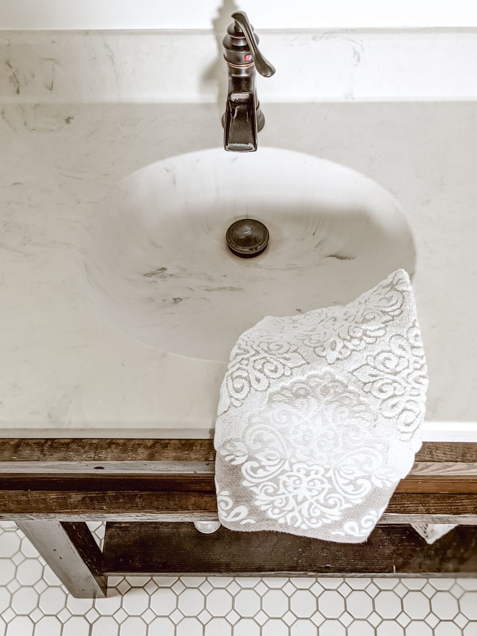 Custom farmhouse vanity with wood base and marble countertops