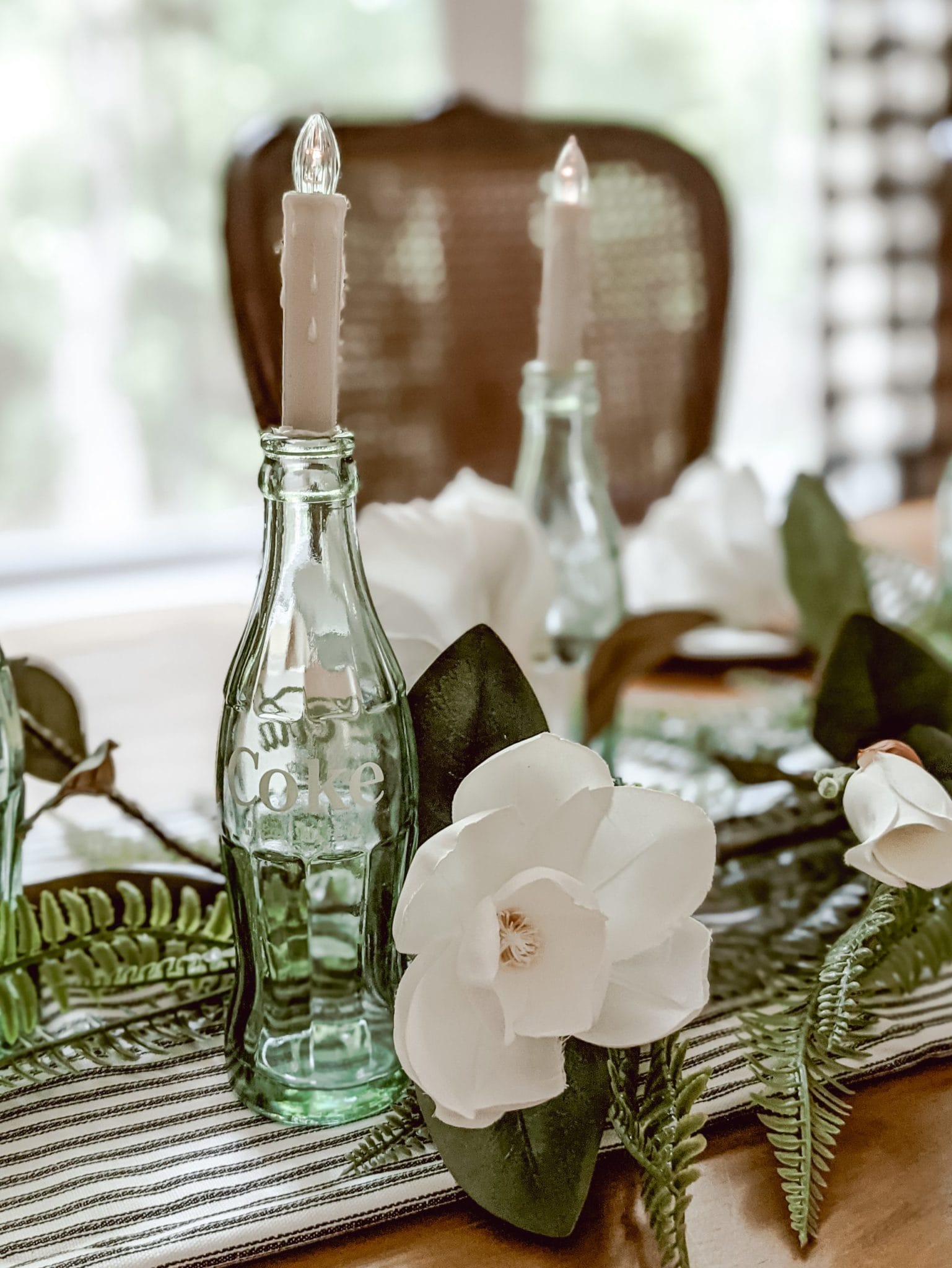 vintage green glass coca cola bottle in centerpiece
