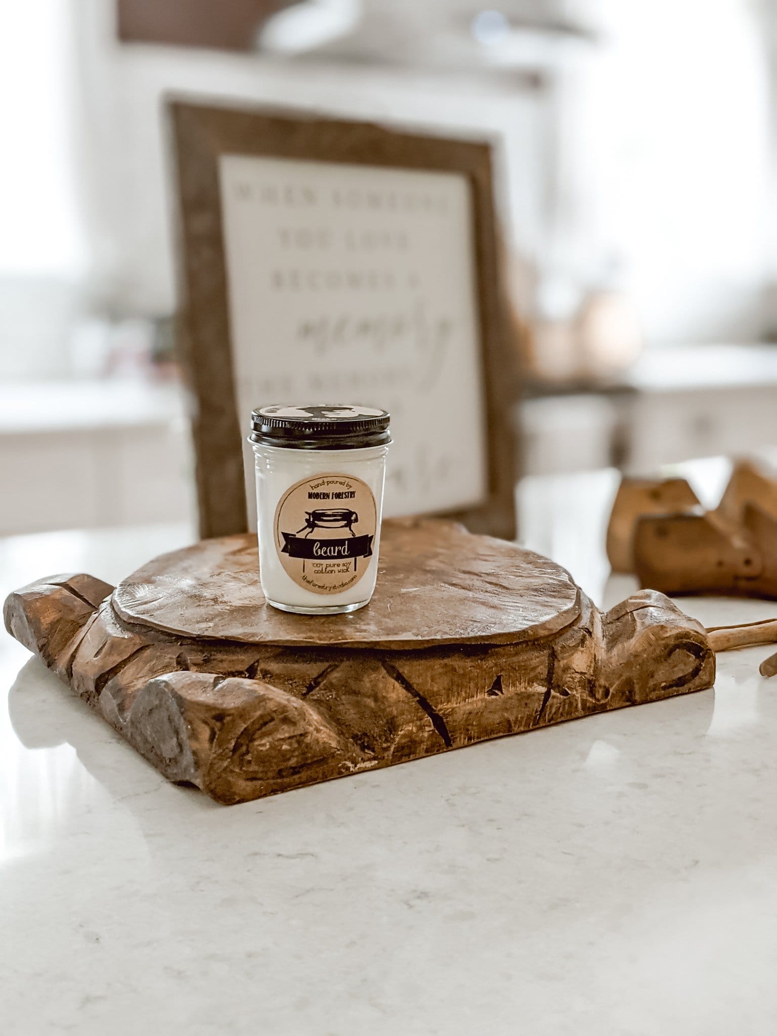 carved details on wooden riser and beard scented candle