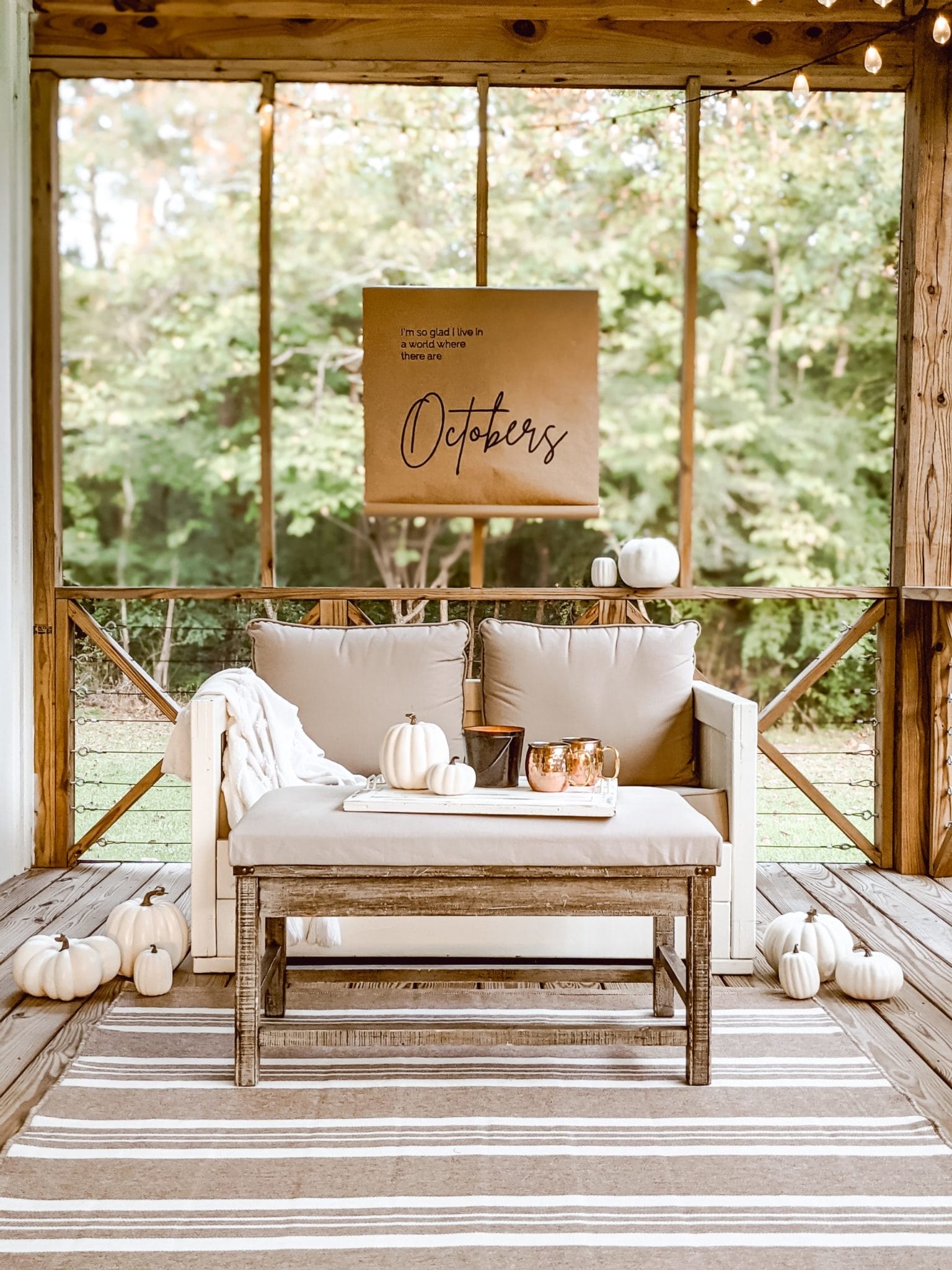 outdoor living area and neutral farmhouse style cozy fall porch decor