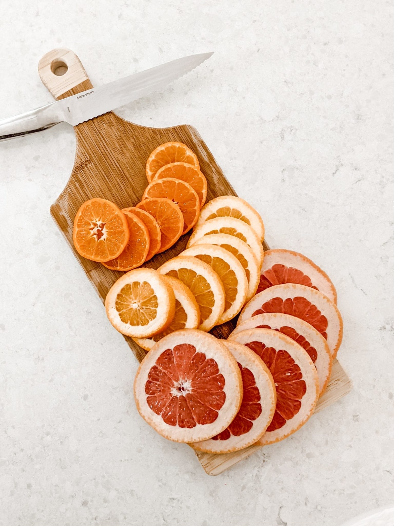 sliced citrus on wood cutting board