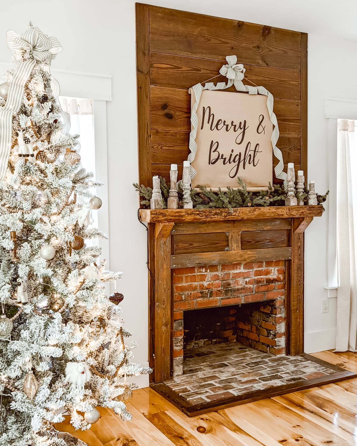 white Christmas bedroom with flocked Christmas tree and a real fireplace and a farmhouse scroll sign