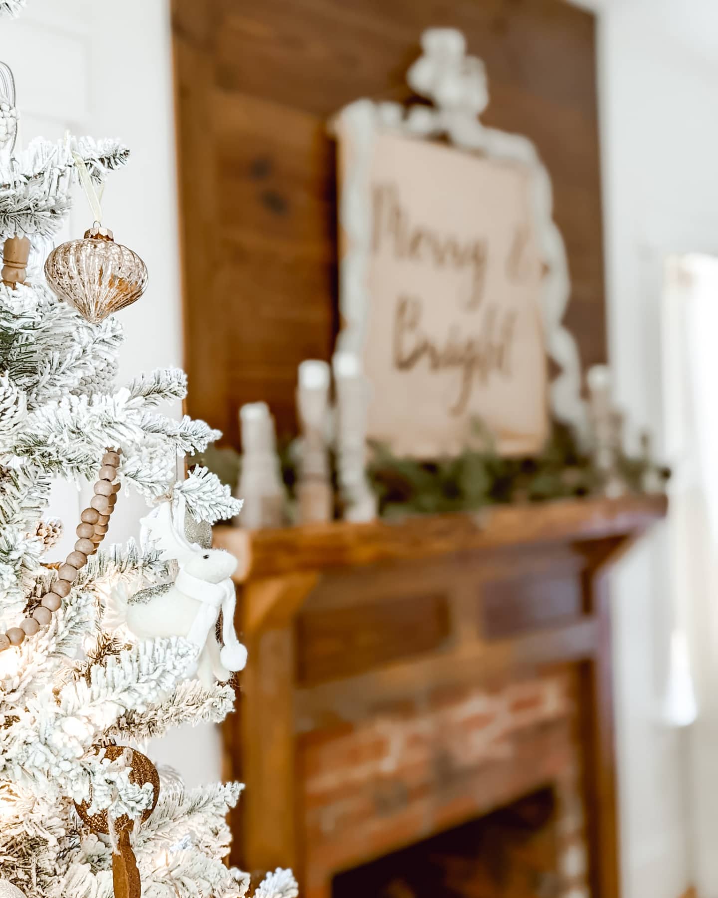 white Christmas bedroom with flocked Christmas tree and a real fireplace