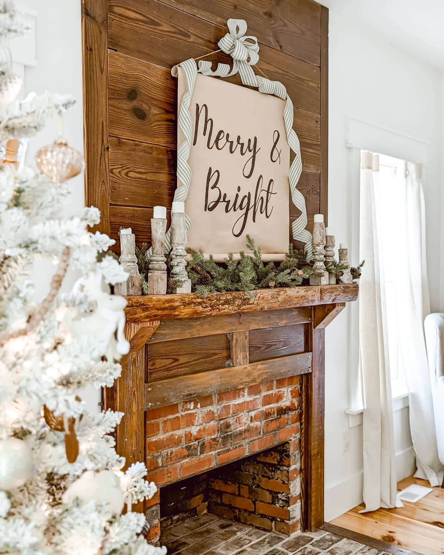 white Christmas bedroom with flocked Christmas tree and a real fireplace