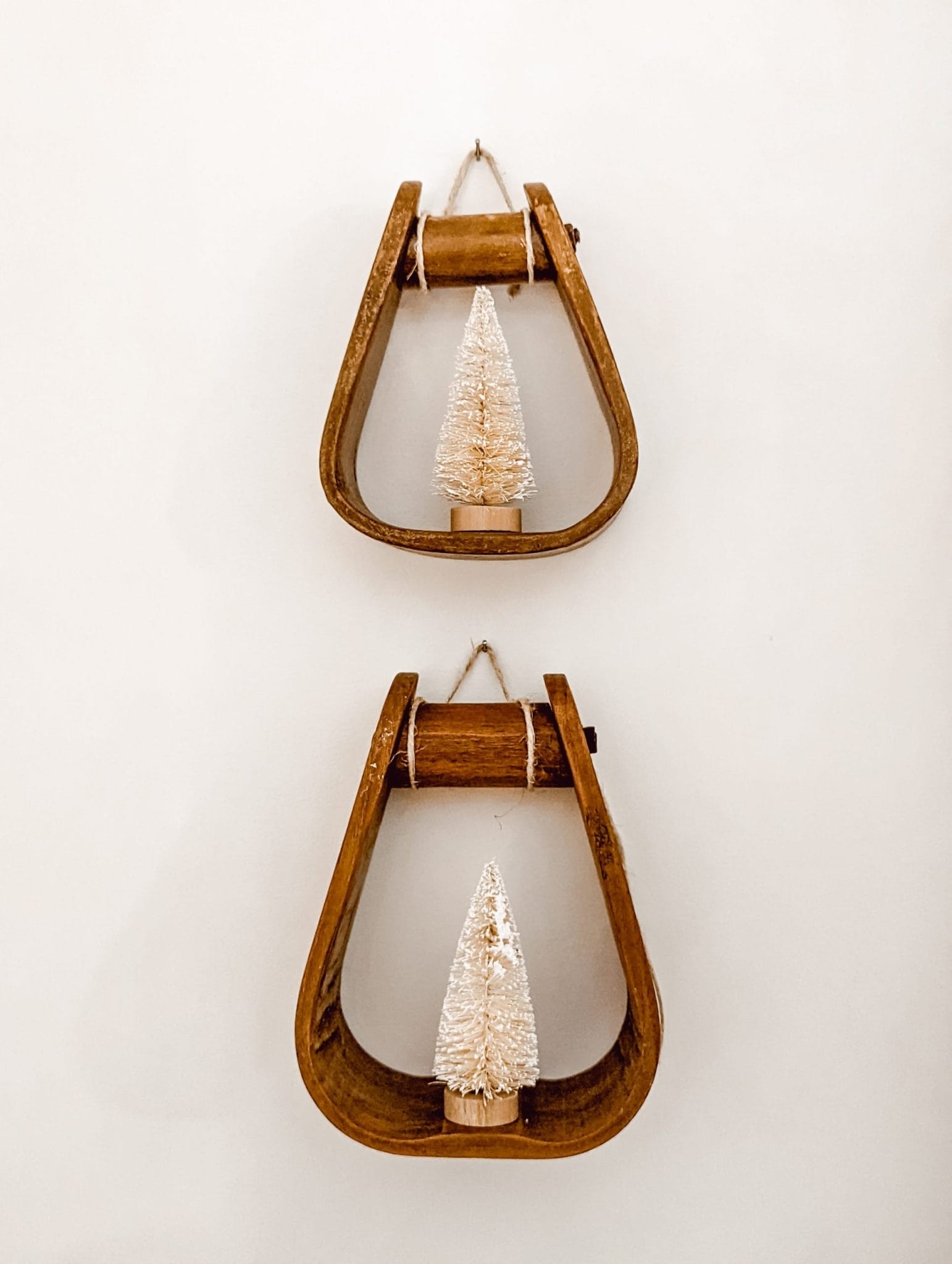 vintage wood stirrups with white bottle brush trees