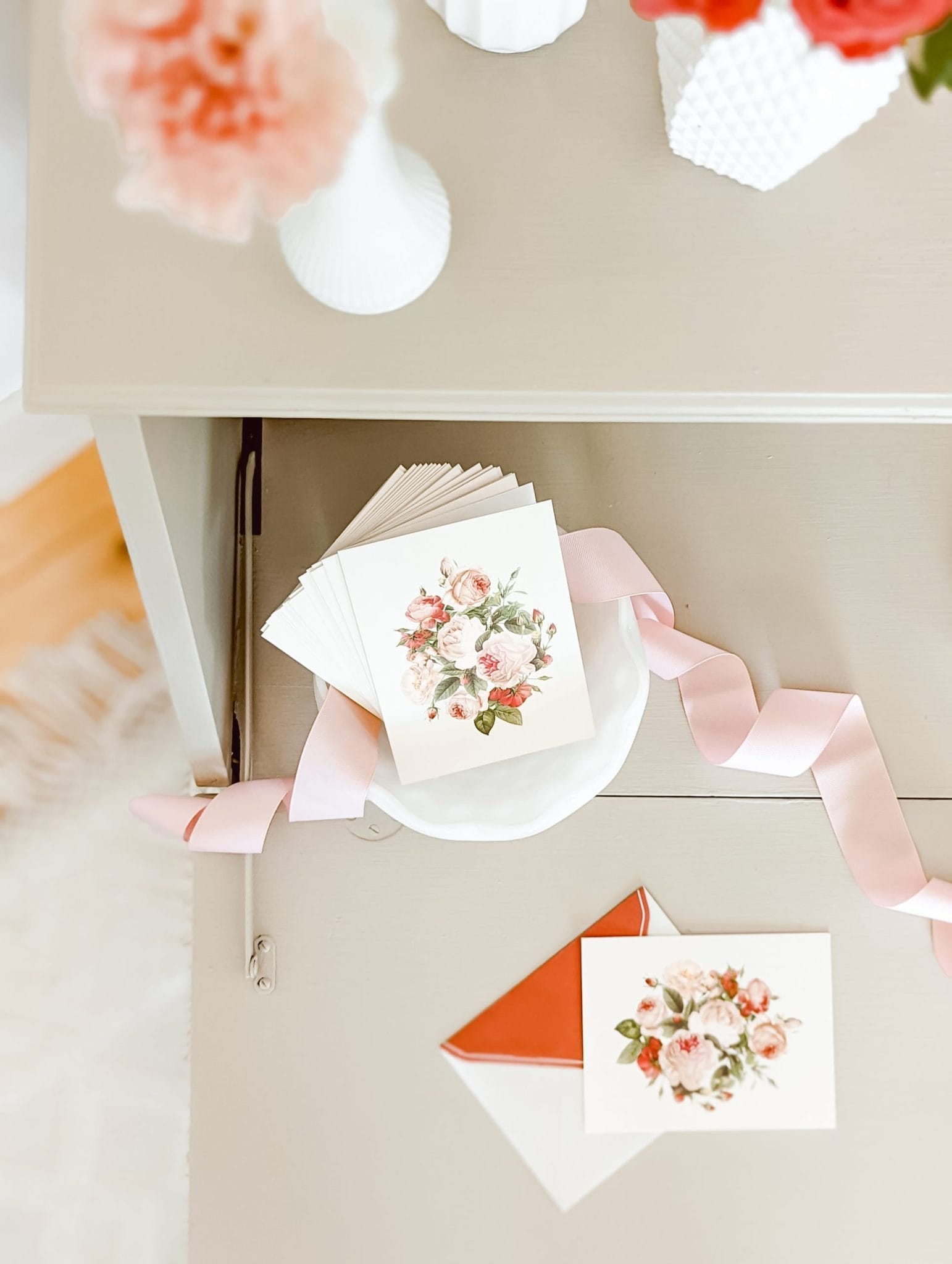 vintage style pink roses on greeting cards in a milkglass bowl