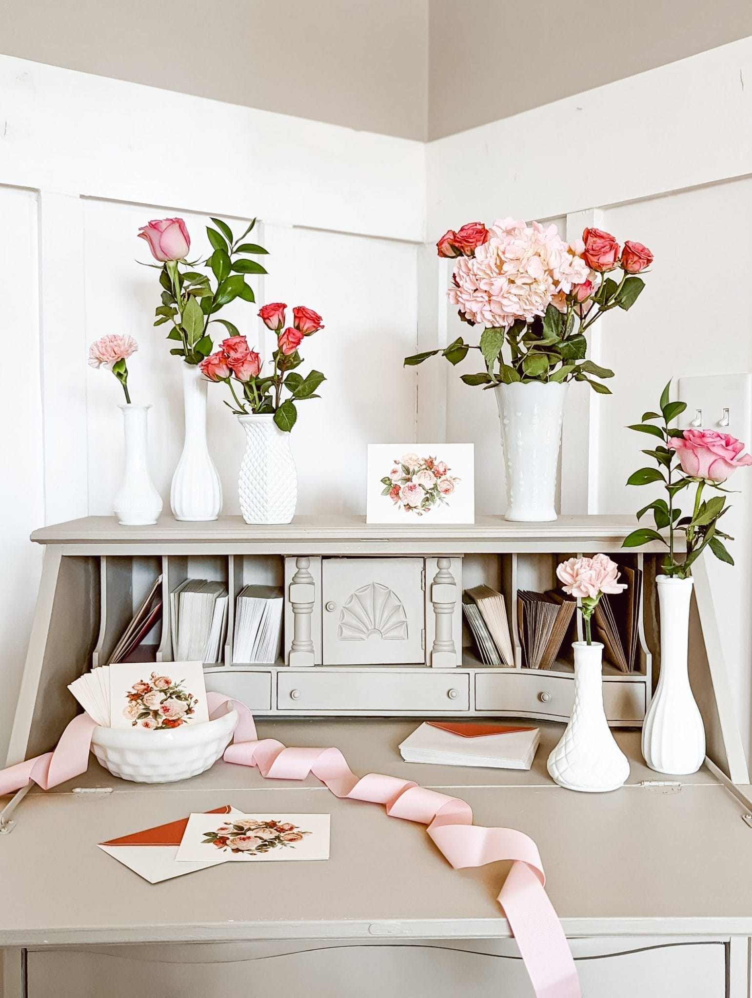 milk glass bud vases and pink roses and vintage rose greet cards