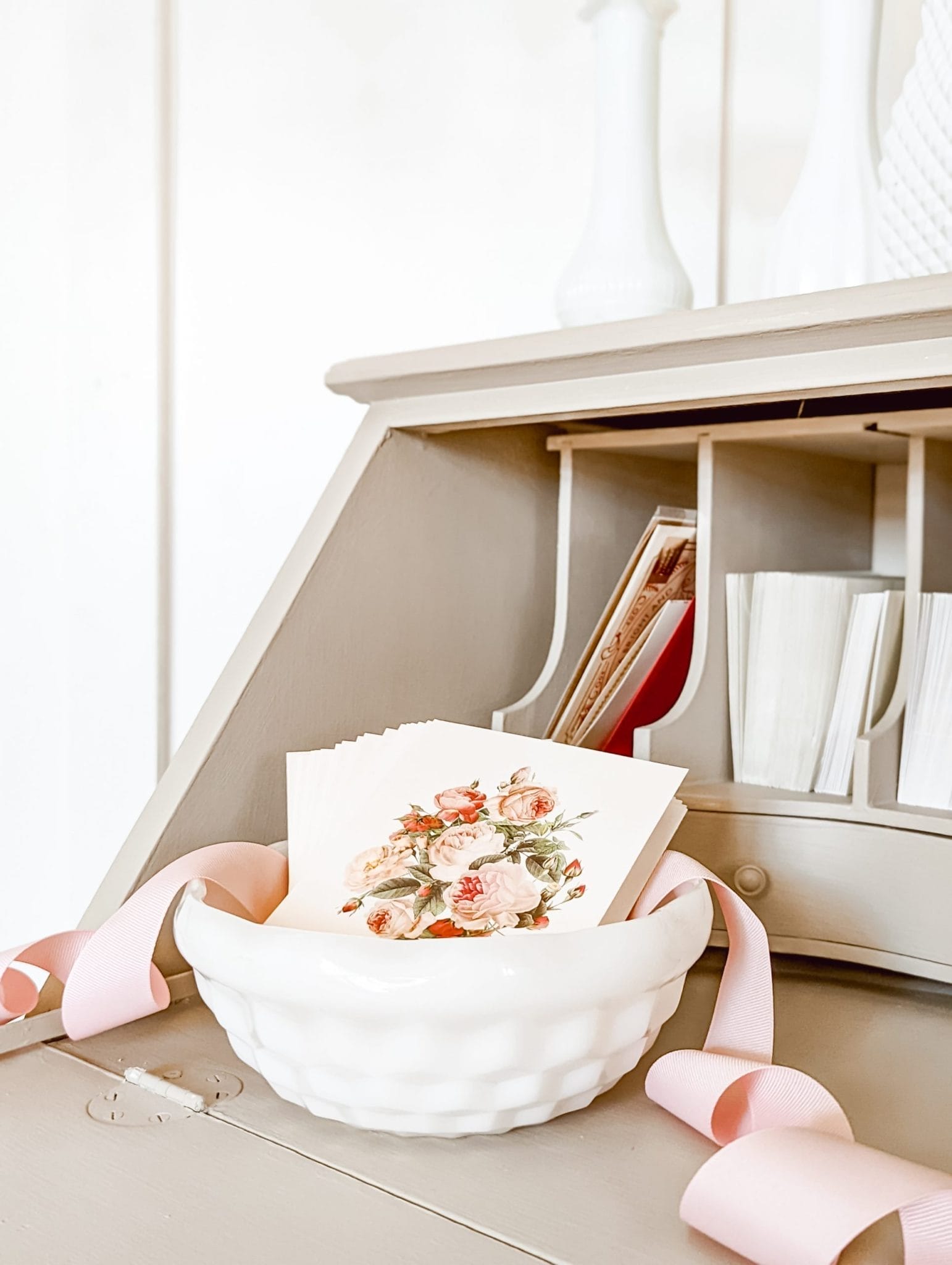 vintage style pink roses on greeting cards in a milkglass bowl