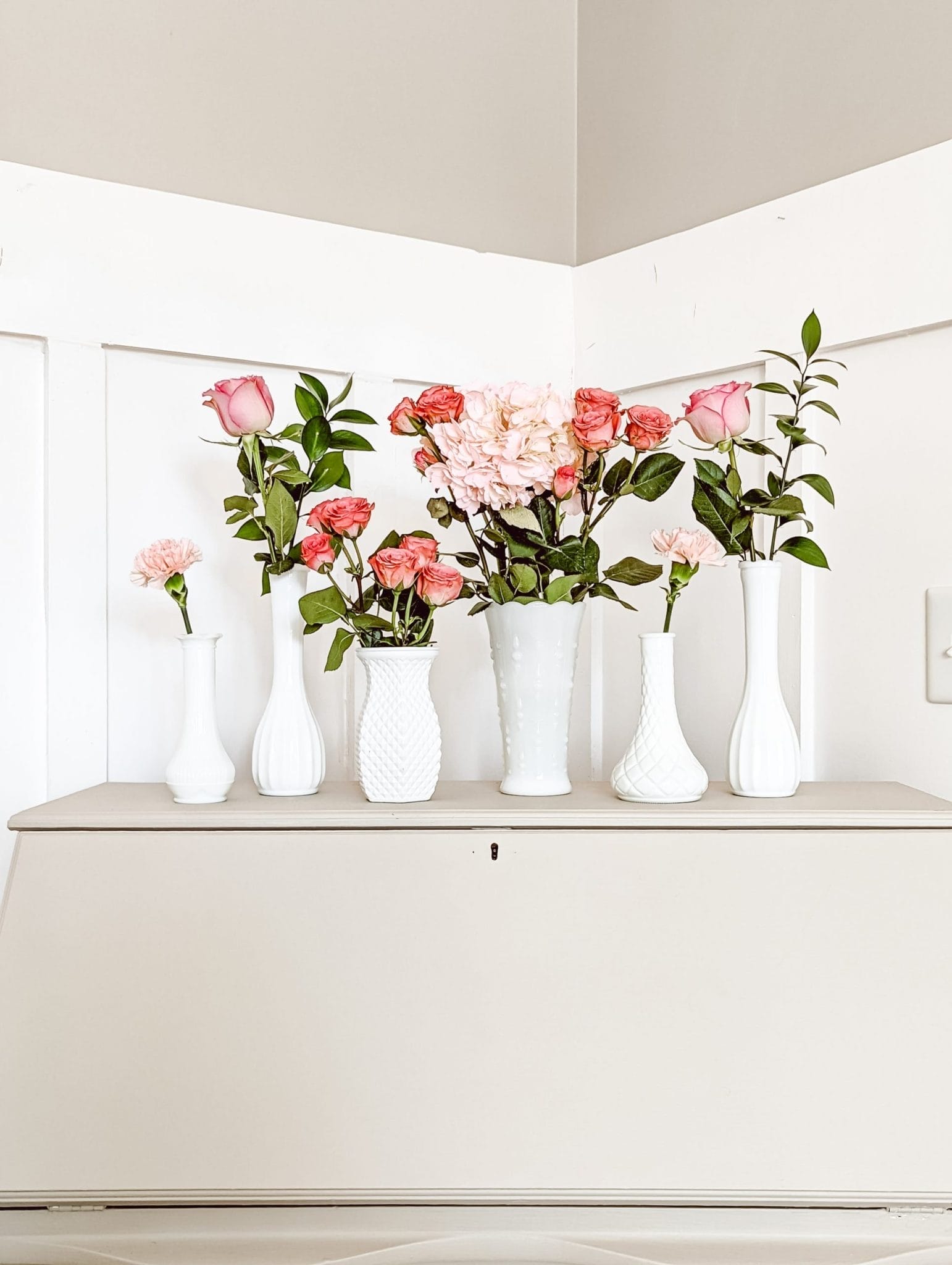 pretty pink roses in vintage milk glass vases