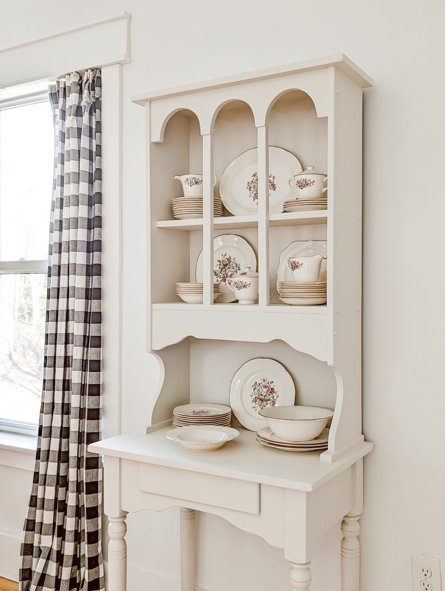 vintage floral china collection on white hutch