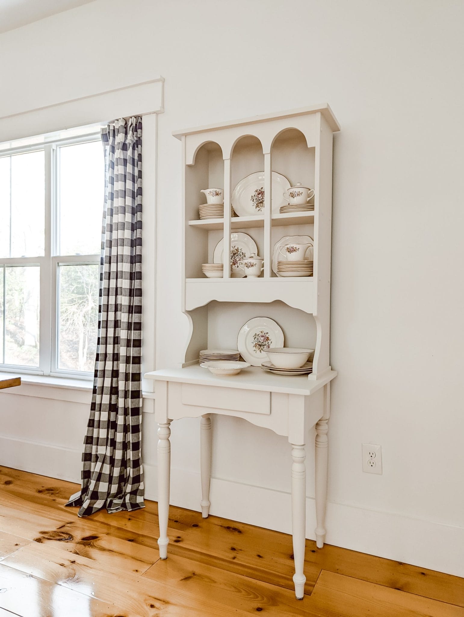 white china hutch painted with Fusion Mineral Paint Raw Silk and decorated with vintage china collection