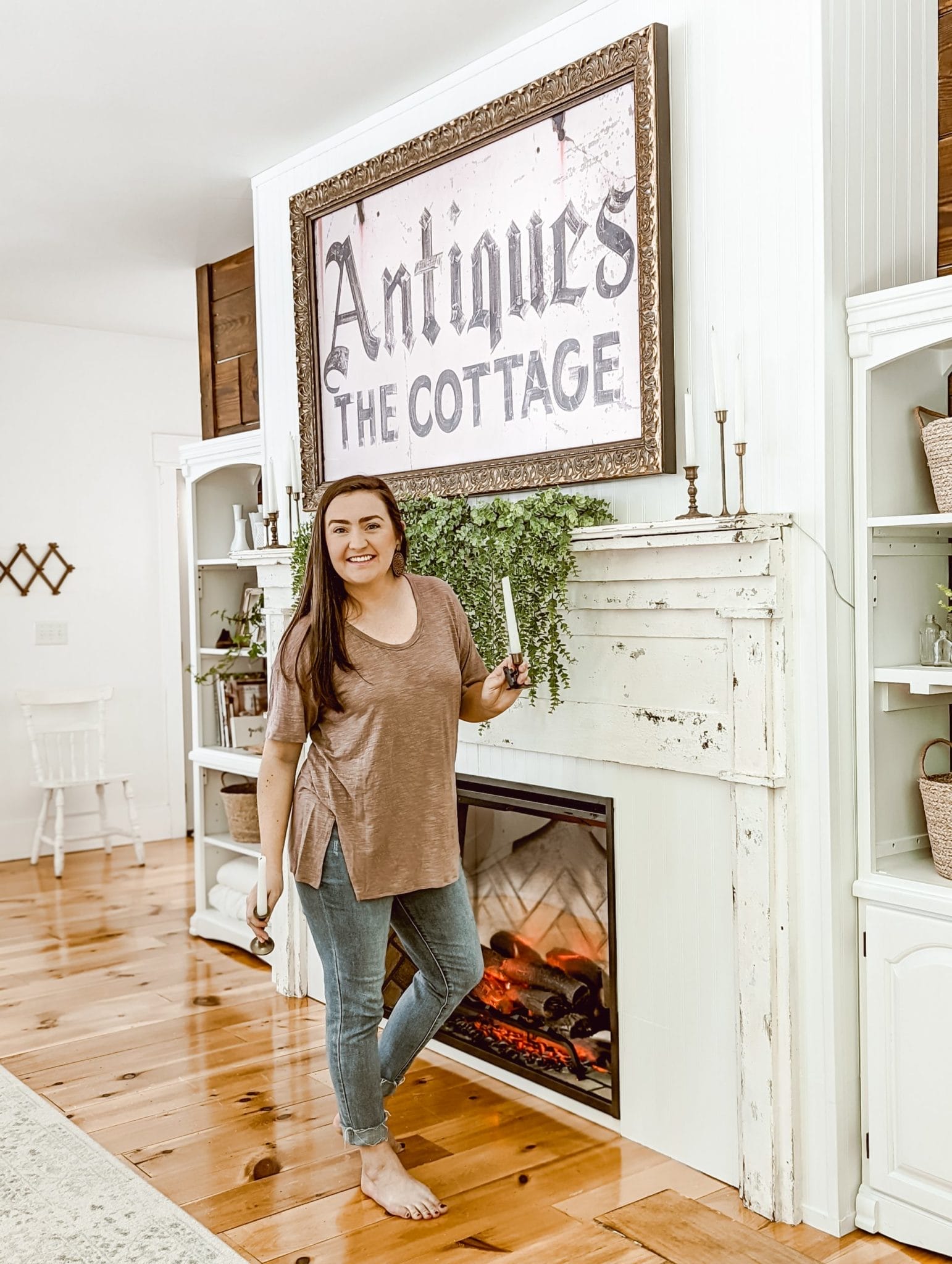 Brittany of White & Woodgrain adding brass candlesticks to our new farmhouse cottage DIY fireplace