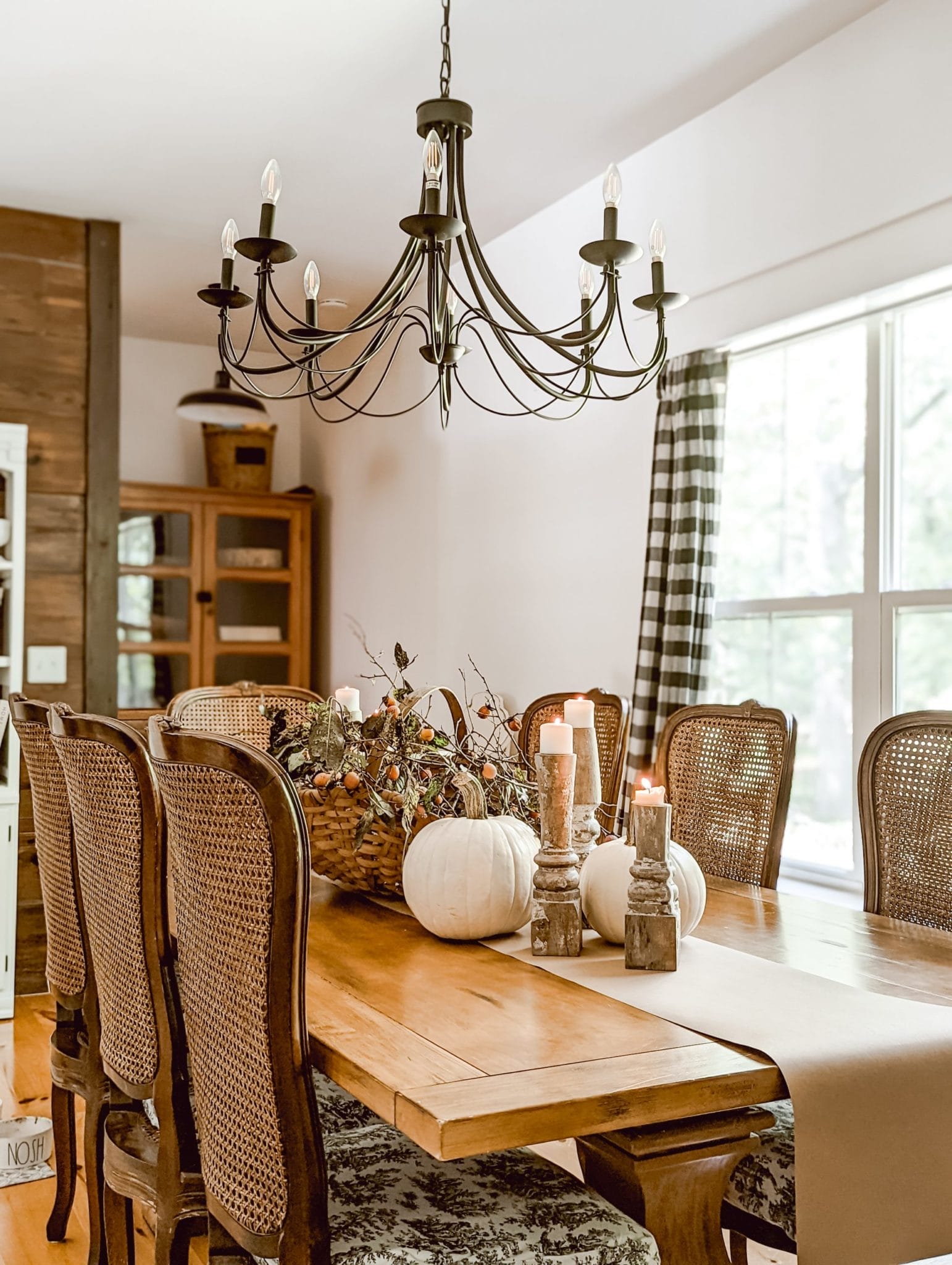 thanksgiving table with white pumpkins, perimmons, and chippy white candlesticks