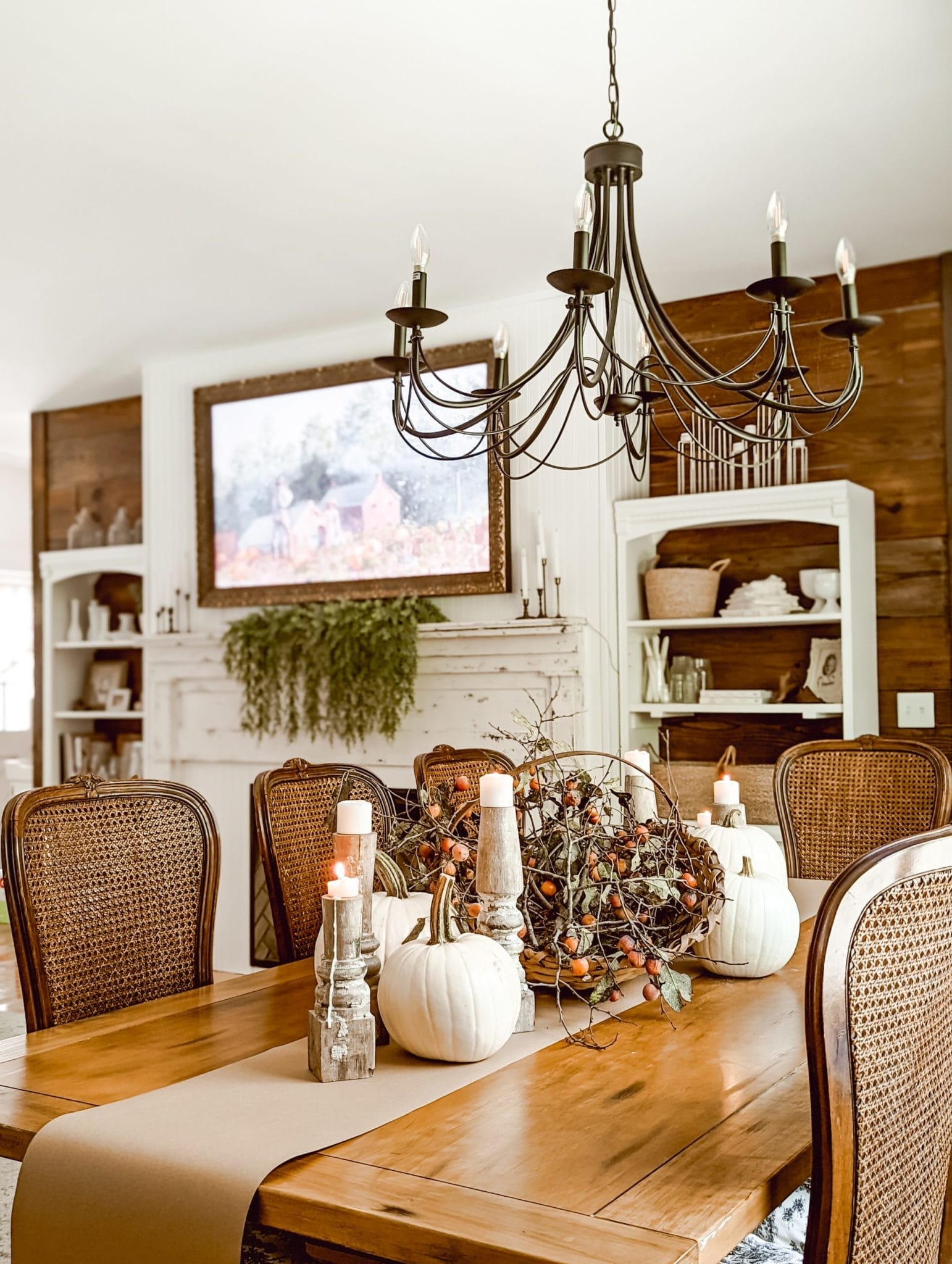farmhouse thanksgiving tablescape with white pumpkins, perimmons, and chippy white candlesticks