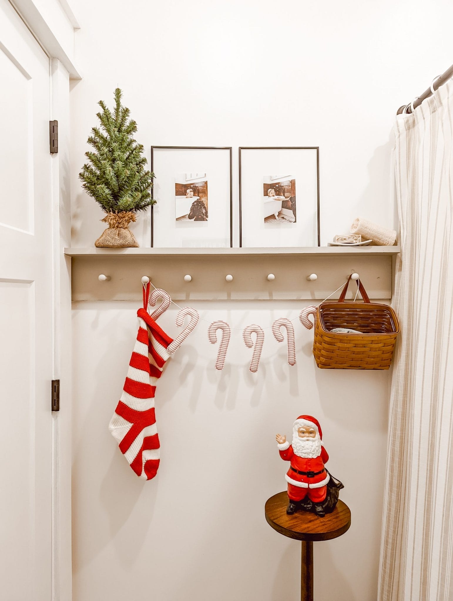 knit stocking and candy cane garland hanging from a peg rail shelf