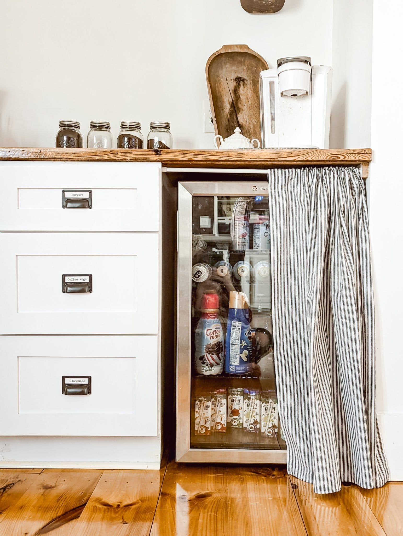 black and white ticking stripe cabinet skirt covering a beverage cooler